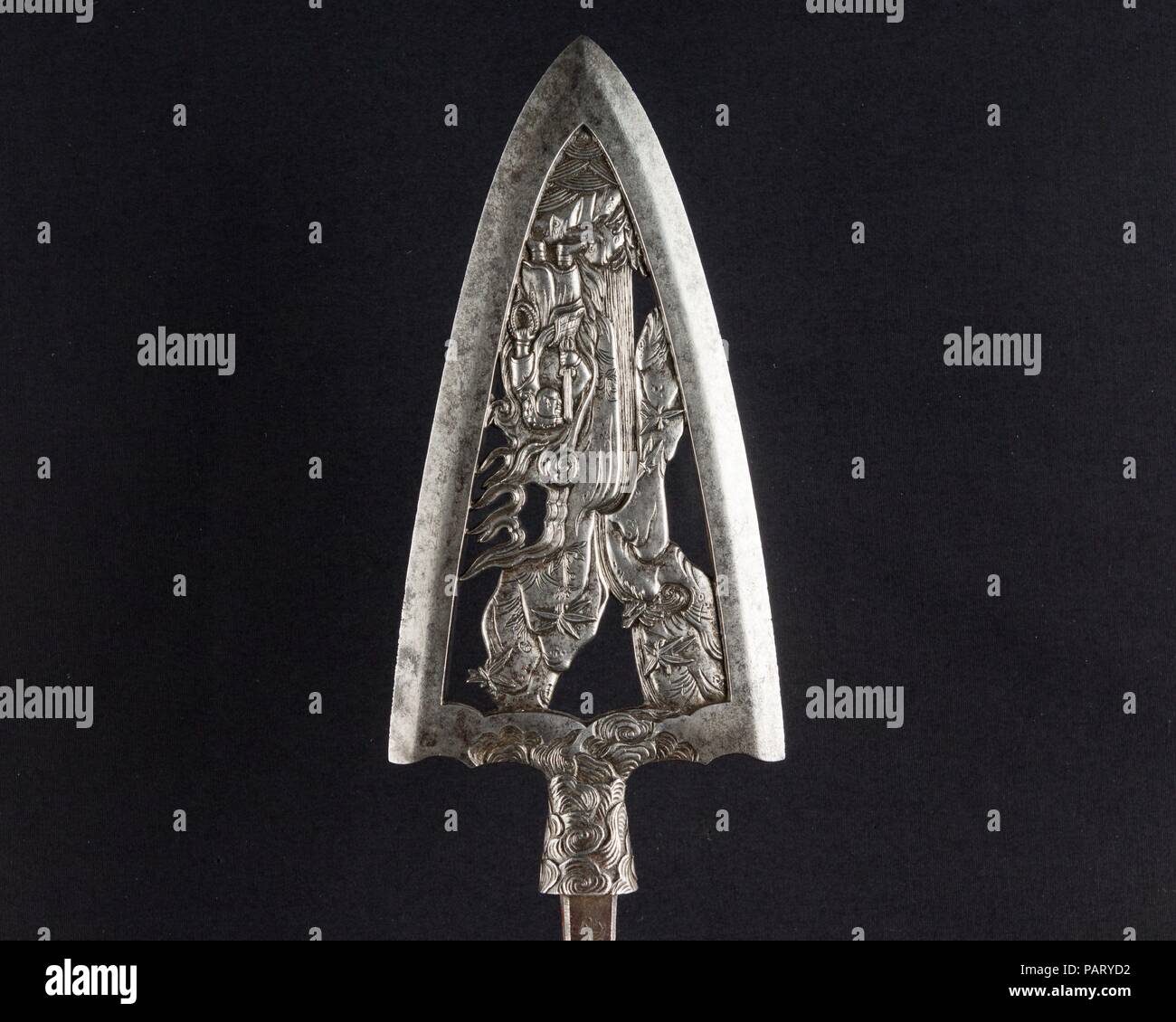 Ceremonial Arrowhead (Yanone). Culture: Japanese. Dimensions: L. 12 3/4 in. (32.4 cm); L. of head 6 in. (15.7 cm); W. 2 3/4 in. (7 cm); Wt. 7.1 oz. (201.3 g). Steel-chiseler: Umetada Motoshige (Japanese, Edo period, died 1675). Date: dated August 1645.  Large arrowheads, pierced and elaborately chiseled with landscapes, birds, flowers, dragons, and Buddhist divinities, were created to be admired for the beauty of their metalwork and design rather than for use in archery. This arrowhead is dated 1645 and signed by Umetada Motoshige (died 1675), a member of the Umetada school of swordsmiths, <i> Stock Photo