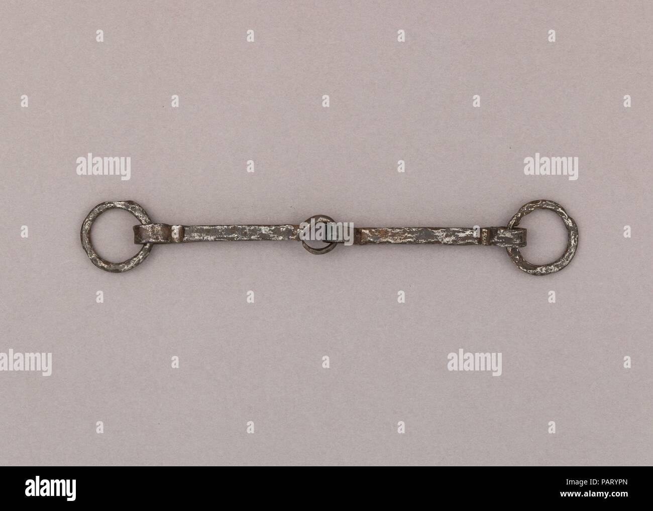 Snaffle Bit. Culture: German. Dimensions: W. 7 3/8 in. (18.7 cm); Wt. 3.9 oz. (110.6 g). Date: 9th-11th century.  If the Vikings are mostly known for being talented sailors, one may forget they were also horse riders, and as in all the Germanic cultures, horses had great importance in their society, in both its social and religious aspects. Equestrian equipment, like stirrups, spurs and bits, are regularly found in Viking burials, among the goods warriors wanted to bring with them to the afterlife. The elite would sometimes even be accompanied by sacrificed horses, a meaningful practice at tha Stock Photo
