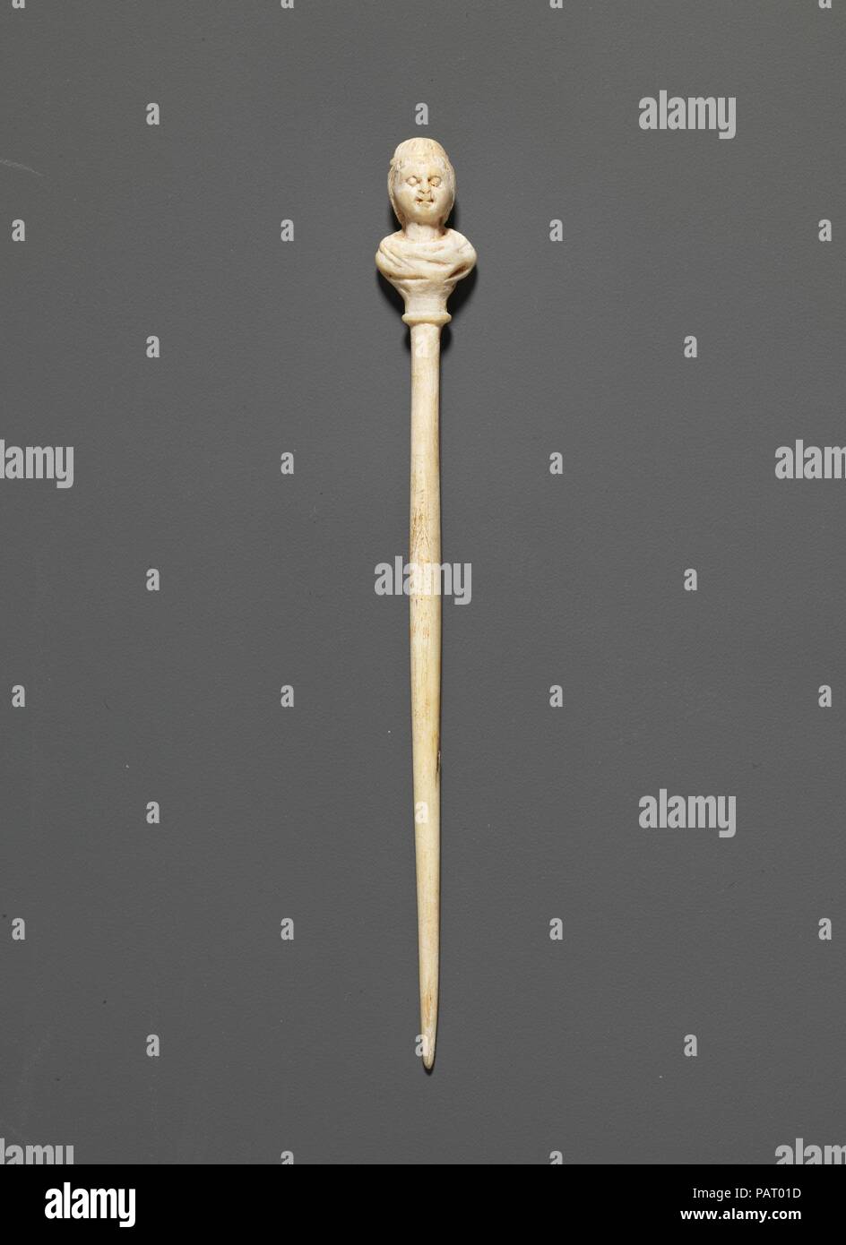Bone pin. Culture: Roman, Cypriot. Dimensions: length  4 3/16in. (10.6cm). Date: 1st-4th century A.D..  The busts were worked separately and attached. Such ornate pins were probably used as hair ornaments. Museum: Metropolitan Museum of Art, New York, USA. Stock Photo