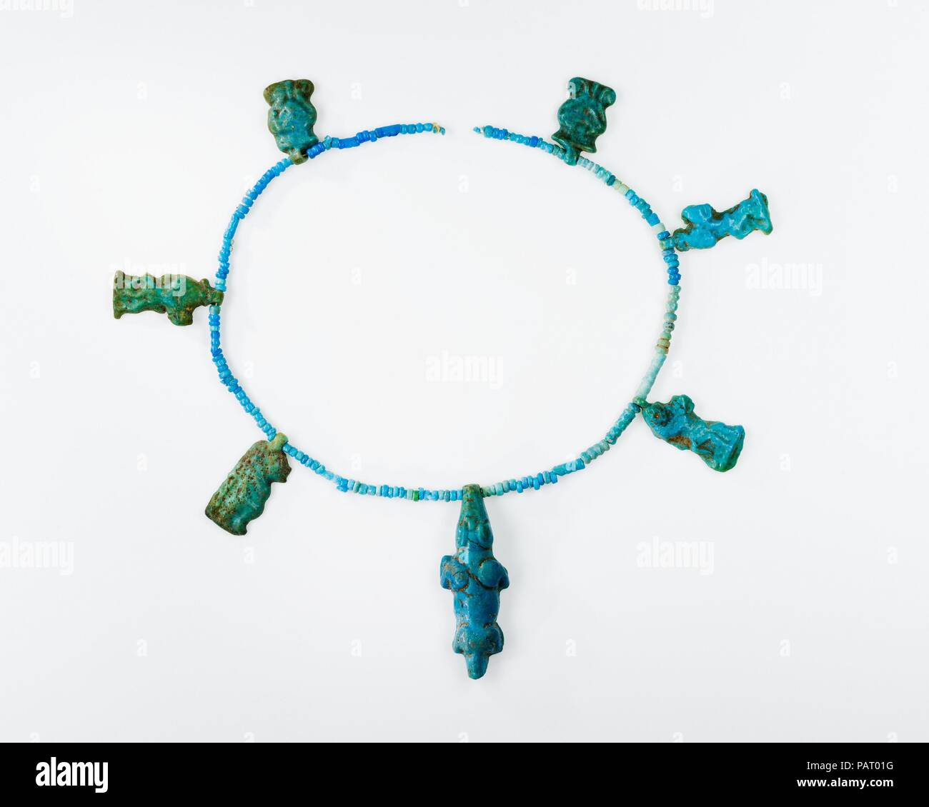 Seven Amulets on a String of Beads. Dimensions: L. of strand 19.5 cm (7 1/2 in.); L of crocodile amulet 3 cm (1 3/16 in.). Dynasty: Dynasty 18. Reign: reign of Amenhotep III. Date: ca. 1390-1353 B.C..  These amulets were found together in a pot that was in the same house as the Menat necklace 11.215.450. They were strung together with the small blue beads to keep them together. Museum: Metropolitan Museum of Art, New York, USA. Stock Photo