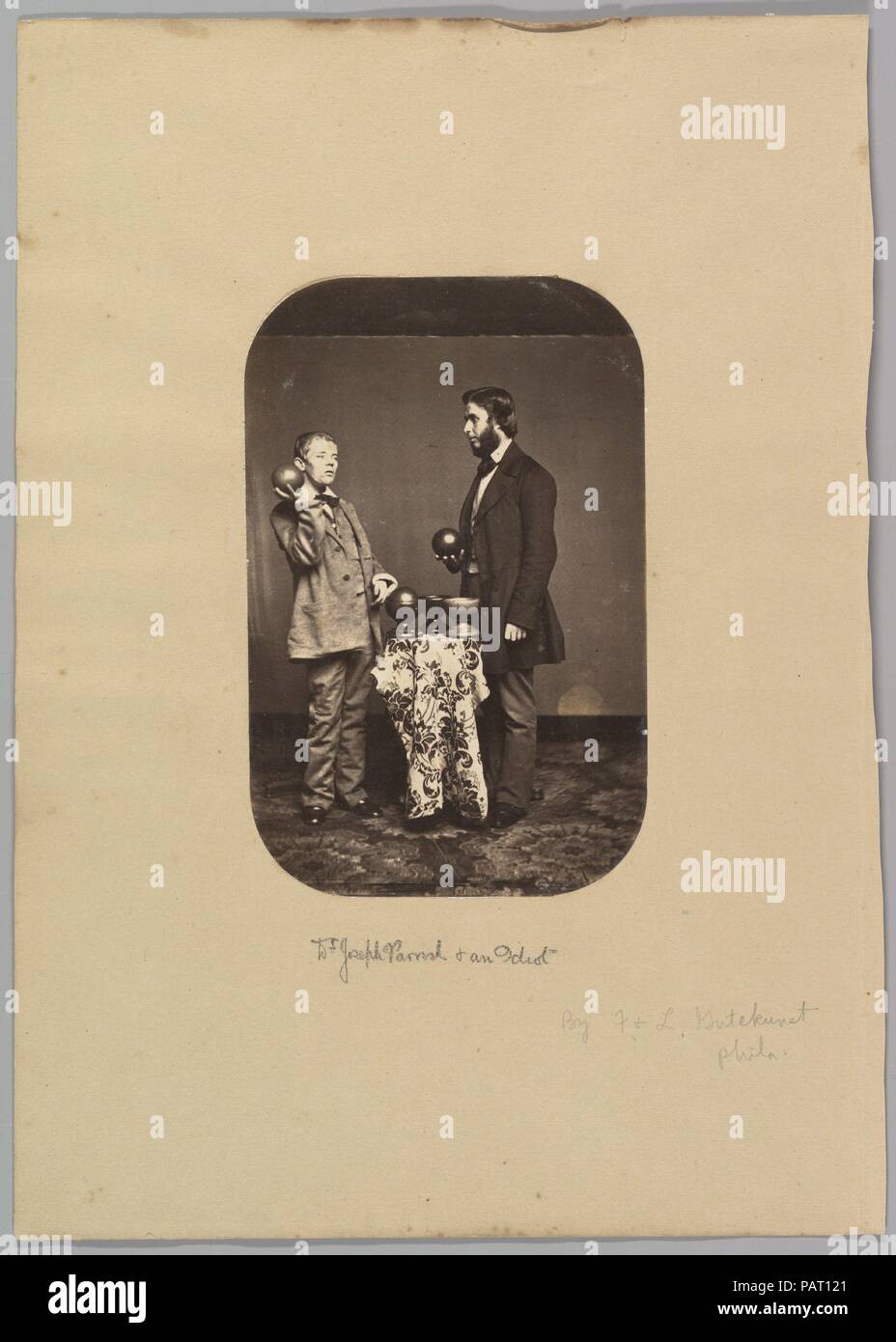 Dr. Joseph Parrish and an Idiot. Artist: Frederick Gutekunst (American, born Germany, 1832-1917). Dimensions: Image: 7 5/16 × 4 3/4 in. (18.6 × 12 cm); (a)  Image: 8 in. × 5 1/4 in. (20.3 × 13.3 cm); (b)  Mount: 14 7/16 × 10 5/16 in. (36.6 × 26.2 cm). Date: ca. 1858. Museum: Metropolitan Museum of Art, New York, USA. Stock Photo