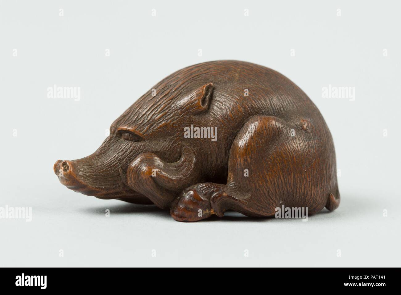 Netsuke of a Boar. Culture: Japan. Dimensions: H. 7/8 in. (2.2 cm); W. 1 1/2 in. (3.8 cm); D. 7/8 in. (2.2 cm). Date: 19th century. Museum: Metropolitan Museum of Art, New York, USA. Stock Photo