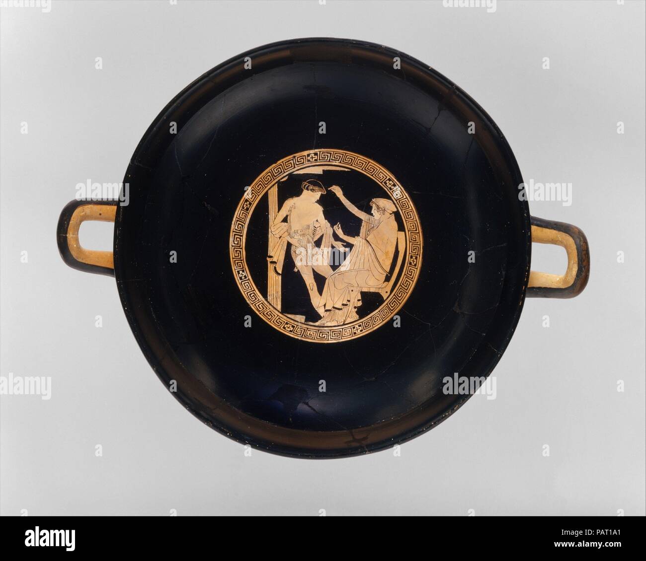 Terracotta kylix (drinking cup). Culture: Greek, Attic. Dimensions: H. 5 3/16 in. (13.2 cm)  width with handles 15 3/8 (39.1 cm)  diameter  12 1/16 in. (30.7 cm). Date: ca. 480 B.C..  Interior and exterior, Theseus in Poseidon's undersea palace and his arrival in Athens  The subject of the decoration is elucidated in a poem by Bacchylides, active in the fifth century B.C. On the interior and one side of the exterior, Theseus, who is bound for Crete to kill the Minotaur, takes leave of his father and stepmother, Poseidon and Amphitrite. On the other side, the victorious Theseus is welcomed back Stock Photo