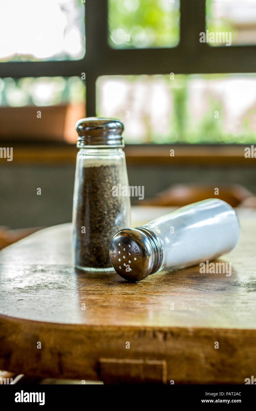 Salt and pepper dispenser on table Stock Photo Alamy