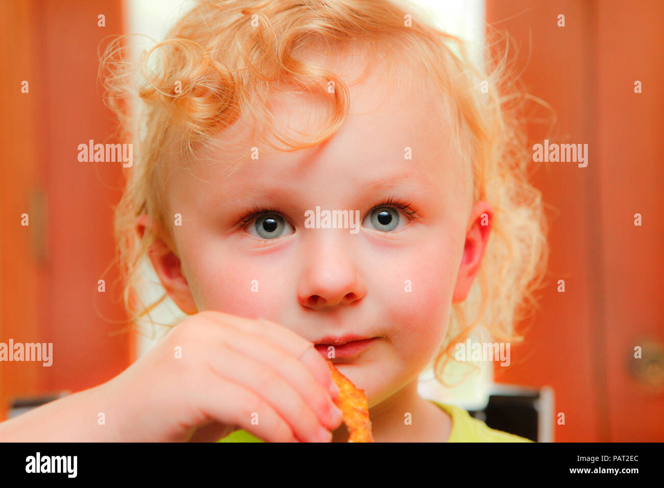 Adorable child eating a snack Stock Photo