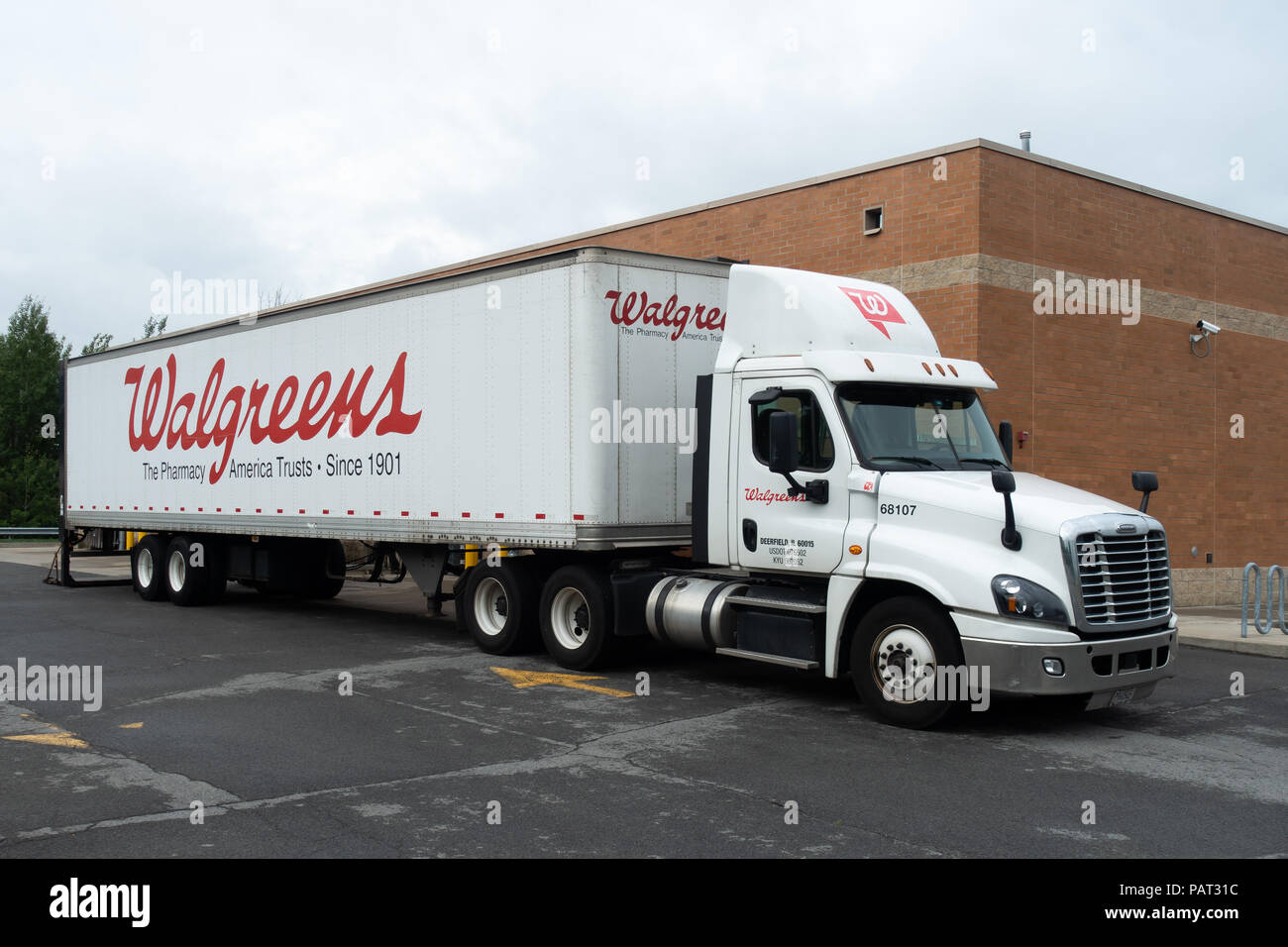 A white Walgreens semi-trailer truck or lorry delivering merchandise to their building in Gloversville, NY USA Stock Photo