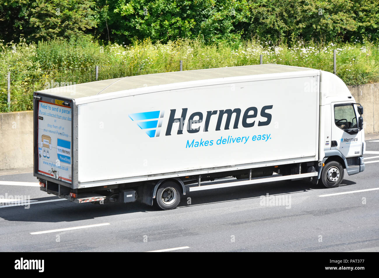 Transportation by Hermes Makes delivery easy says advertising slogan on side of supply chain transport hgv lorry truck M25 motorway Essex England UK Stock Photo