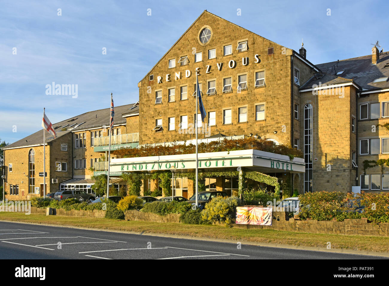 Late evening summer sunshine on front façade Rendezvous Hotel reception entrance backing onto Leeds Liverpool Canal Skipton North Yorkshire England UK Stock Photo