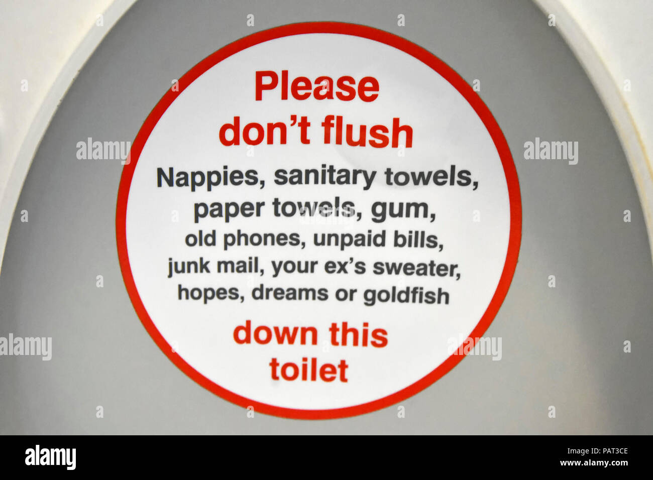 Public transport humour onboard passenger train toilet seat lid humourous instructions items not to flush down loo lavatory pan WC London England UK Stock Photo