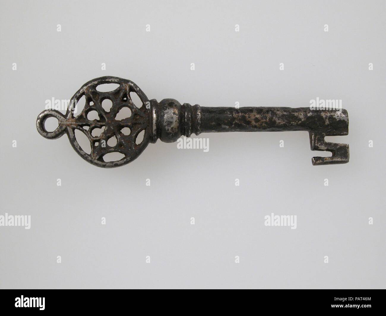 Key. Culture: German. Dimensions: Overall: 4 7/16 x 1 1/4 x 5/8 in. (11.2 x 3.2 x 1.6 cm). Date: 15th century.  The decoration of Gothic iron locks and keys was often elaborate and of the highest standard of workmanship. The motifs were frequently drawn from Gothic architecture, reproducing on a miniature scale complicated tracery patterns and even tiny statuettes. A number of these tiny locks were compound, with some of the mechanisms concealed from view, and required two or even three keys used in sequence to open them. It has been suggested that the greatly expanded use of locks on doors, o Stock Photo
