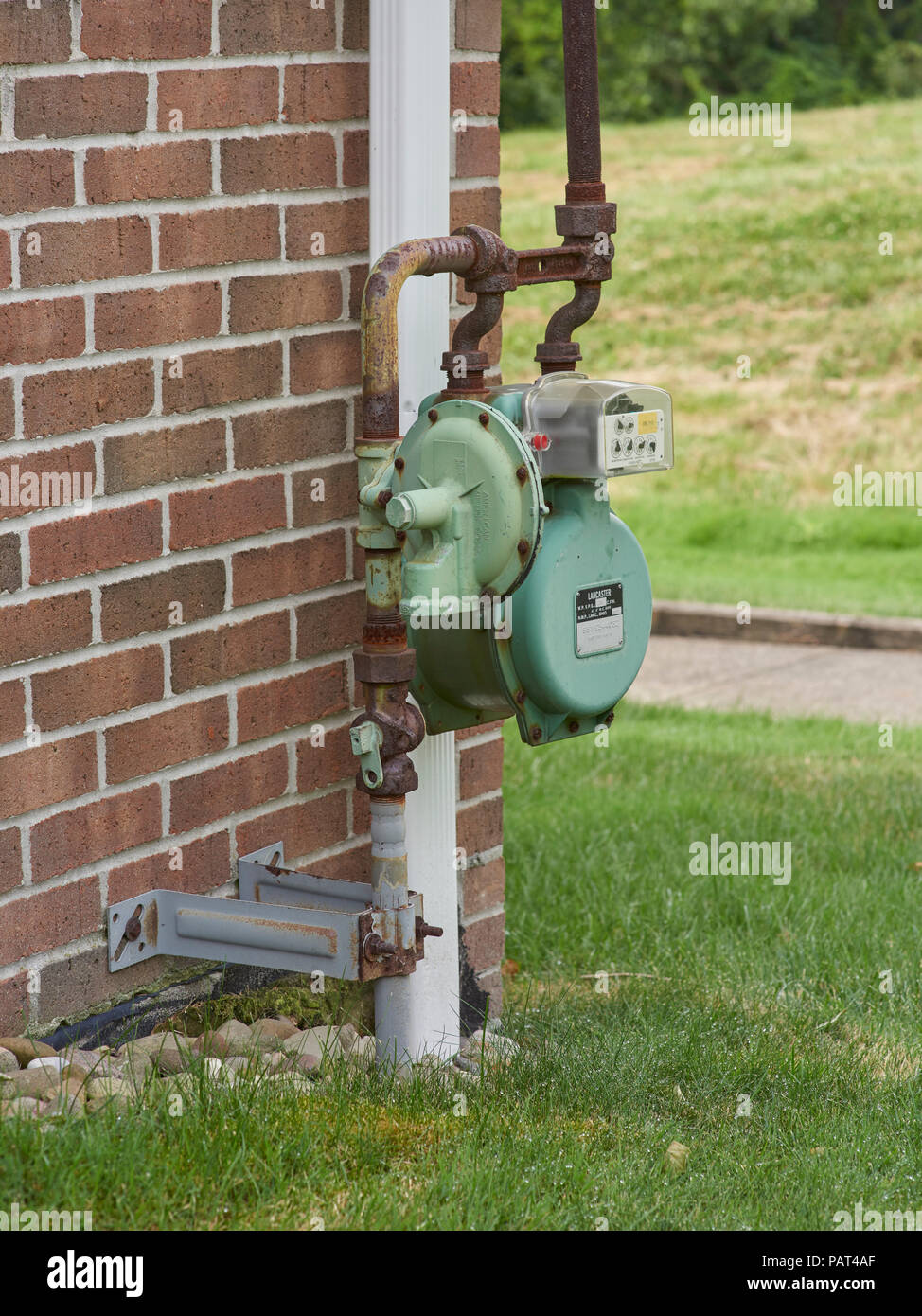 Natural gas meter attached to side of house Stock Photo Alamy