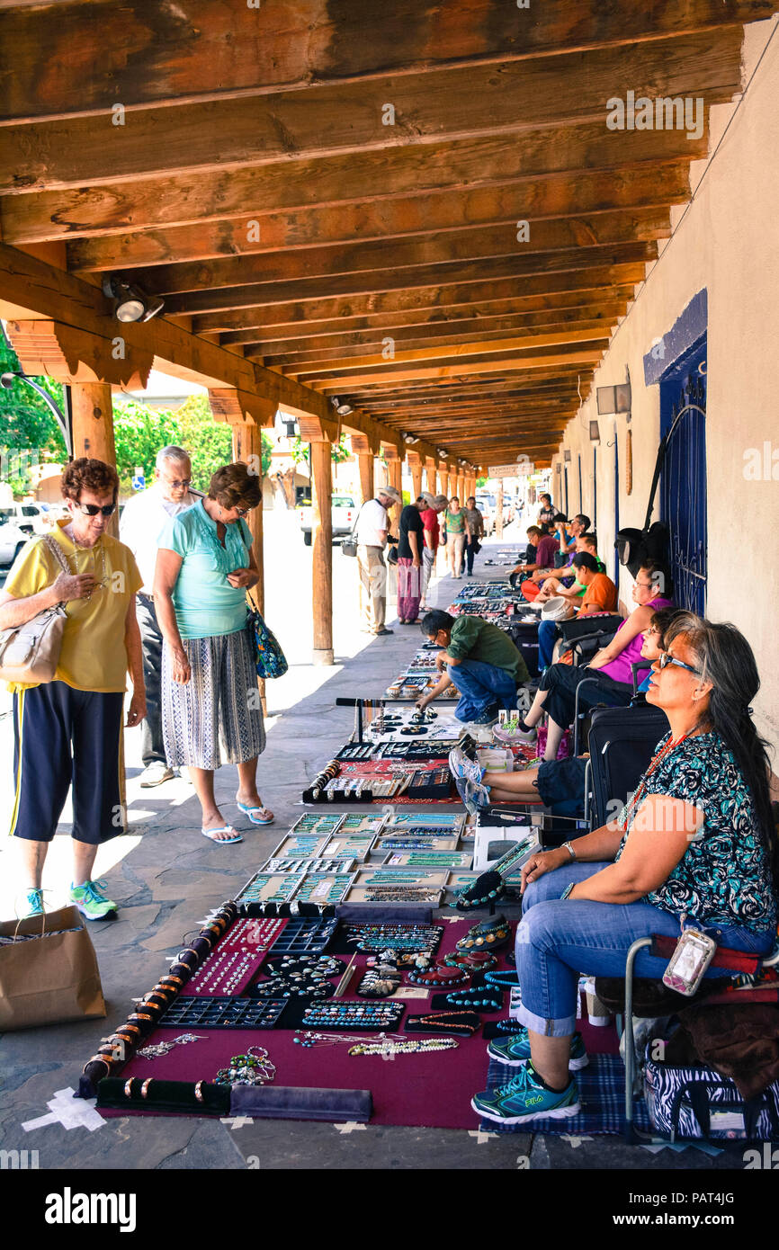 Local native Americans sell their art and jewelry outside the La Placita restaurant with tourists shopping in old town plaza in Albuquerque, NM Stock Photo