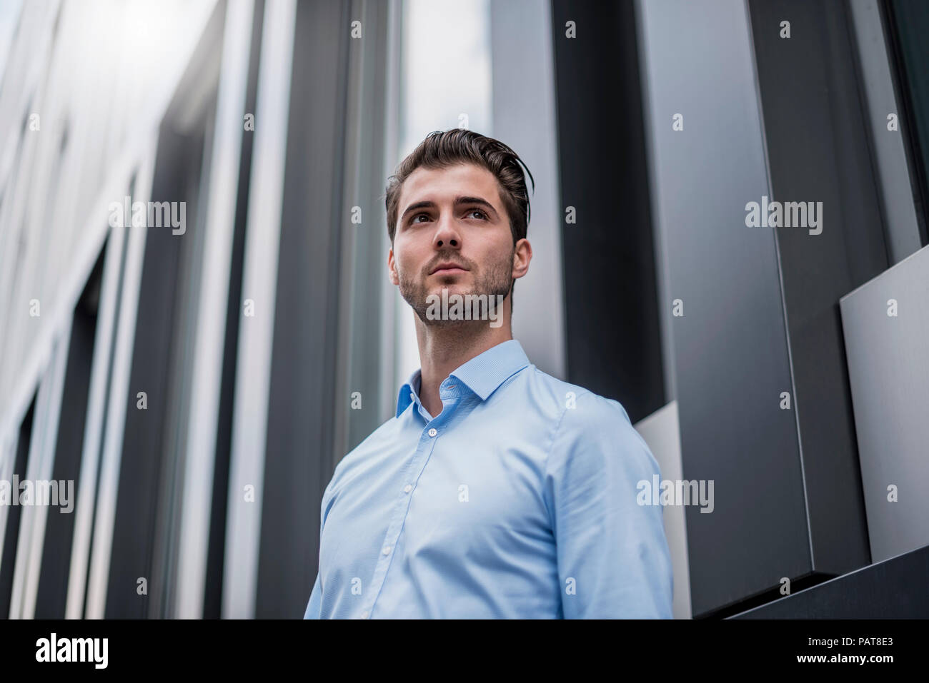 Young businessman in the city outside office building Stock Photo