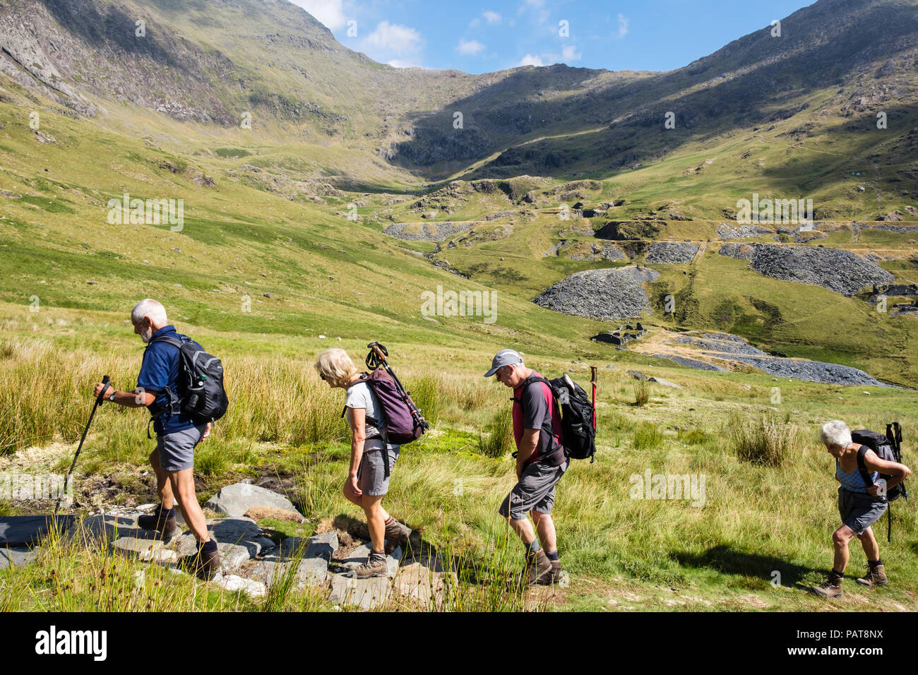 Senior hikers hiking on path to Snowdon south ridge in mountains of Snowdonia National Park (Eryri). Bethania, Cwm Llan, Gwynedd, Wales, UK, Britain Stock Photo