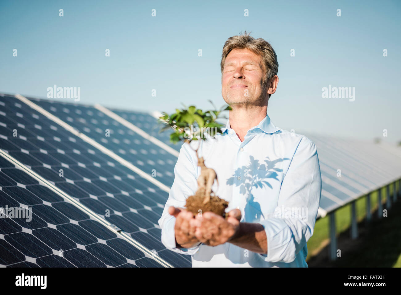 Mature man looking at privet, solar plant Stock Photo