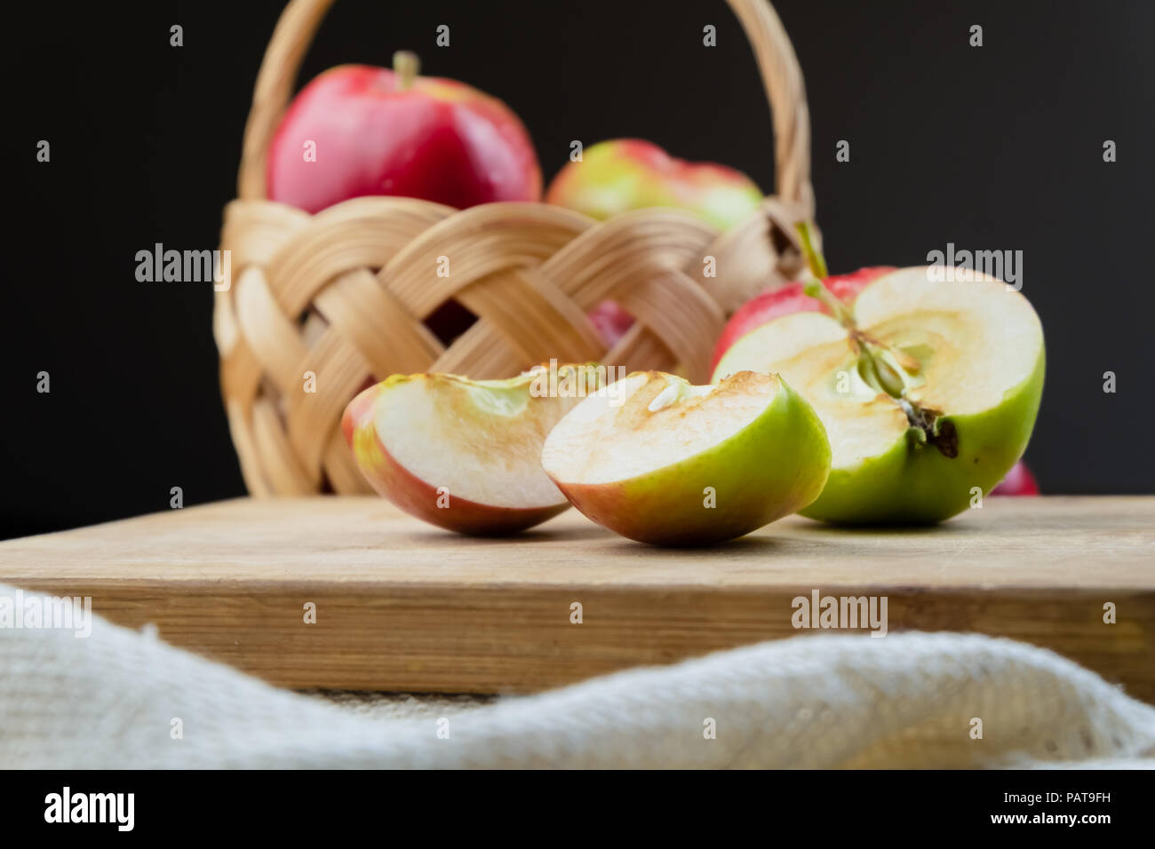 Close-up of ripe juicy apples on wooden table. Home grown organic apples cut in half Stock Photo