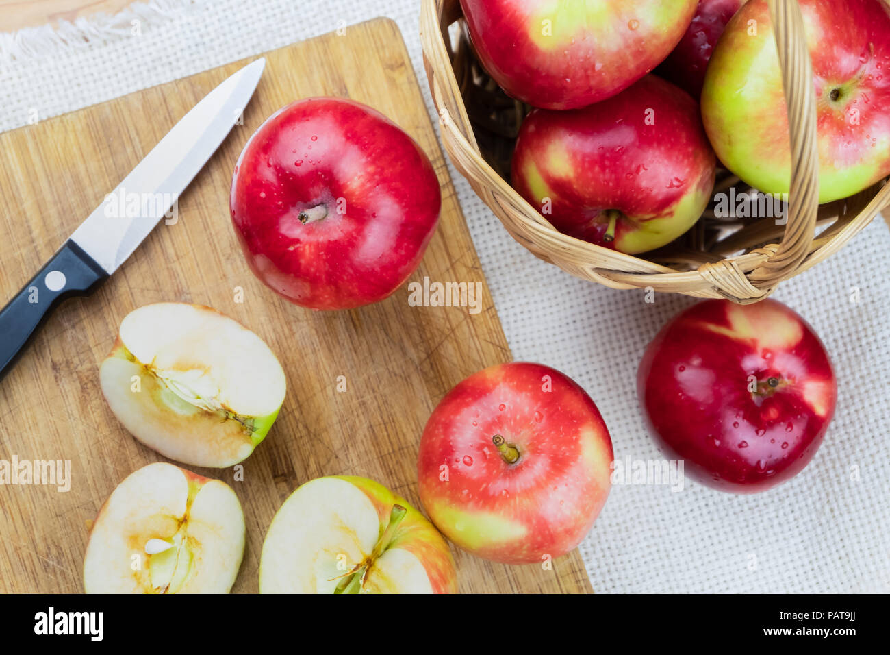 Top view of ripe juicy apples on rustic wooden table. Home grown organic apples and knife, shot from above Stock Photo
