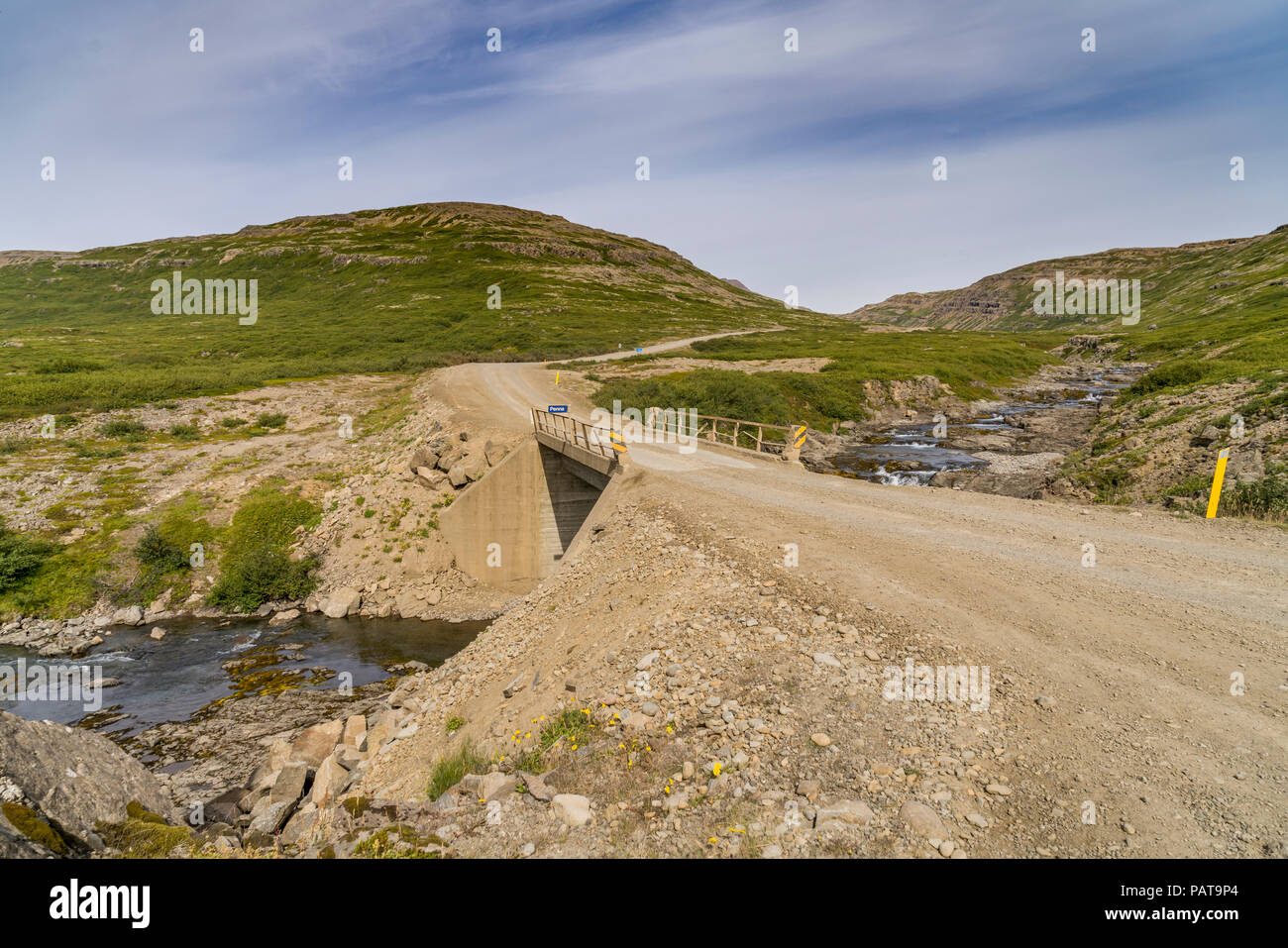 Country road and bridge by the Penna River, Flokalundur, West Fjords, Iceland Stock Photo