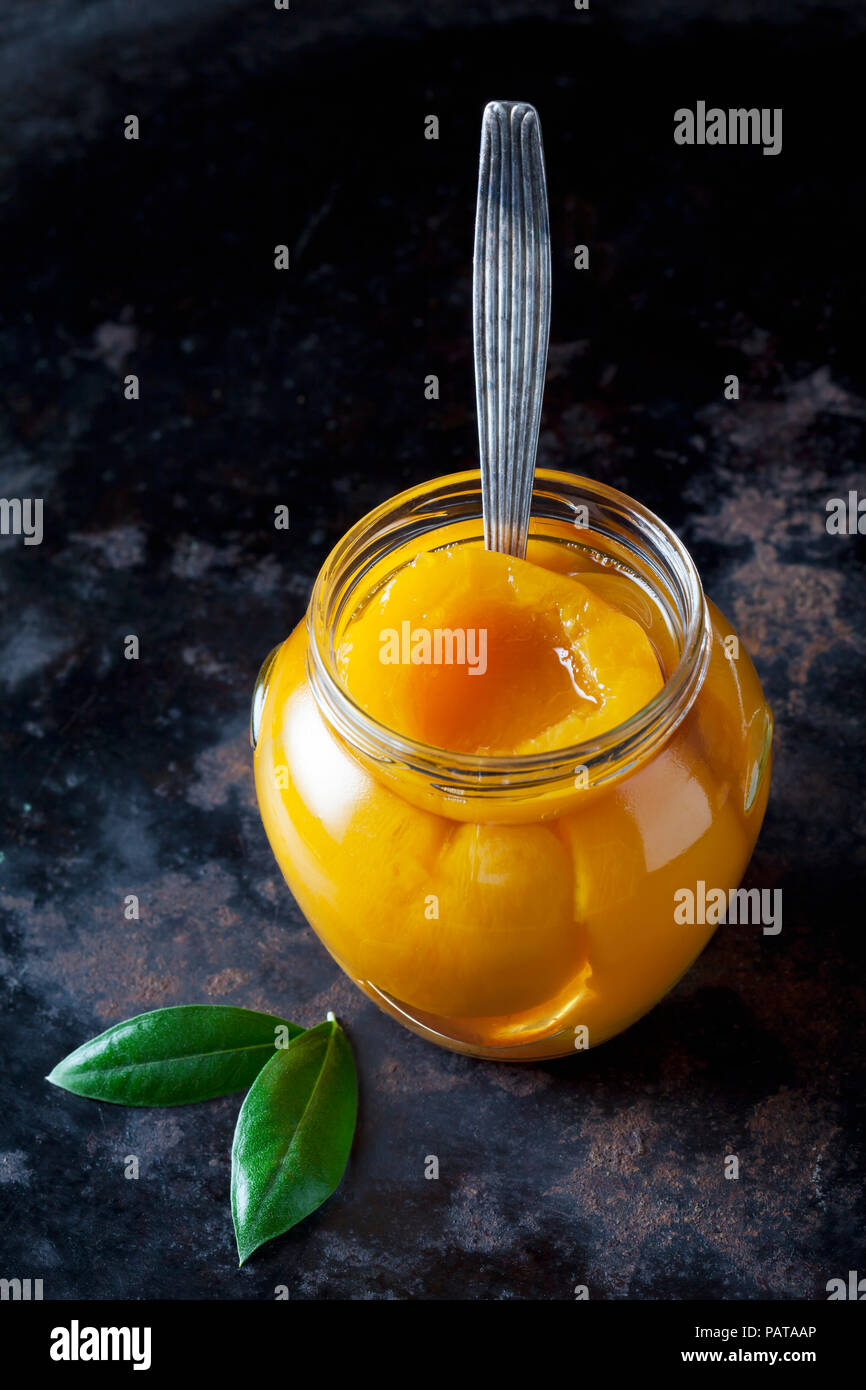 Glass of preserved peach halves Stock Photo