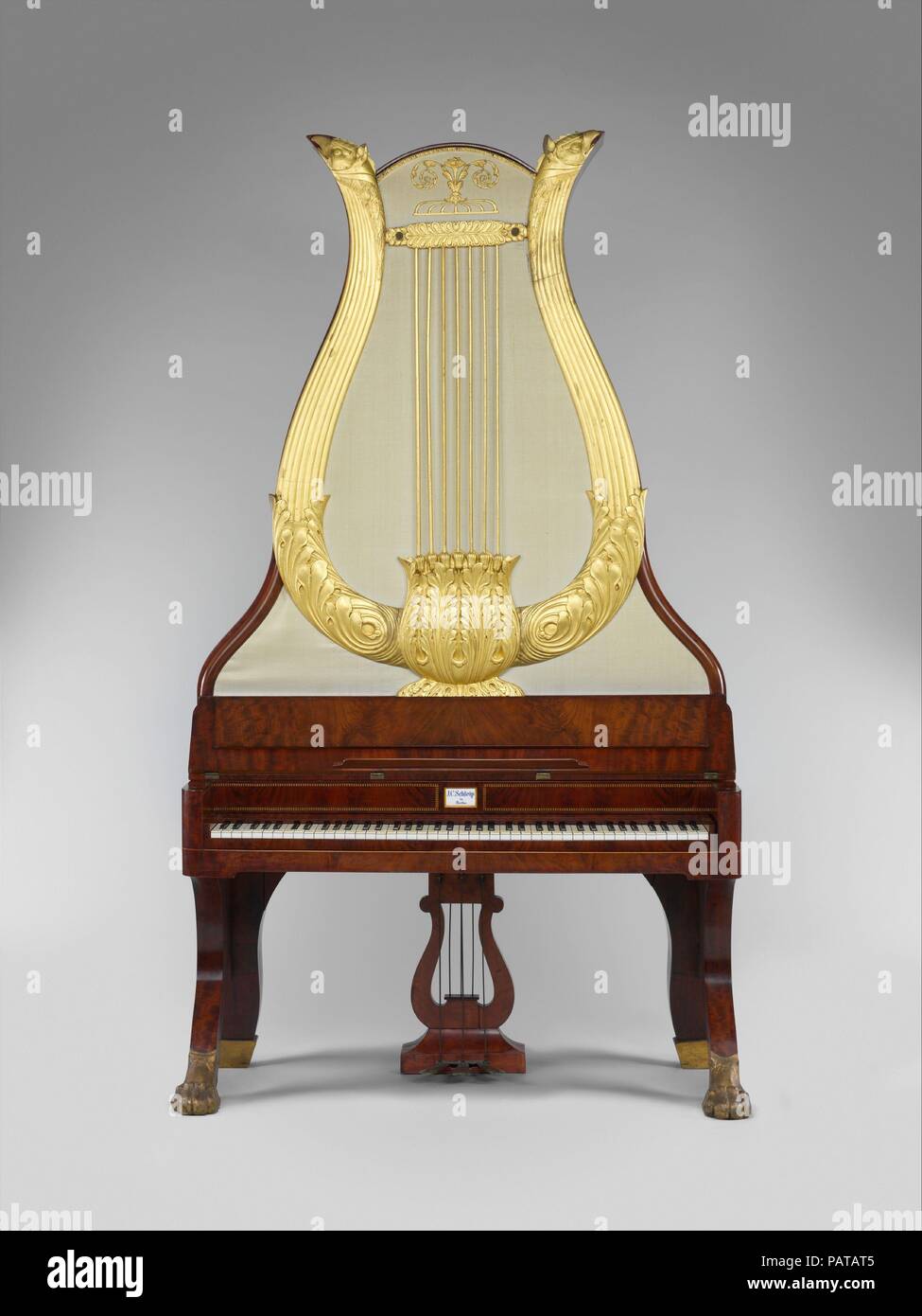Lyraflügel. Culture: German. Dimensions: H. 7' 3';  W. 49 in., D. 2 ft.  Case L (perpendicular to keyboard):  60.3 cm (23 3/4 in.)  Case W (parallel to keyboard): 124 cm (48 13/16 in.)  Total H: 222.5 cm (87 5/8 in.)  String sound L.: longest 141 cm (55 1/2 in.), shortest 4.5 cm (1 13/16 in.), c² 29.9 cm (11 3/4 in.)  3-octave span: 48.1 cm (18 15/16 in.). Maker: Johann Christian Schleip (1786-1848). Date: ca. 1820-44.  This type of upright piano was made almost exclusively in Berlin between 1820 and 1850. The Lyraflügel was a fashionable fixture of middle-class Biedermeier parlors in northern Stock Photo