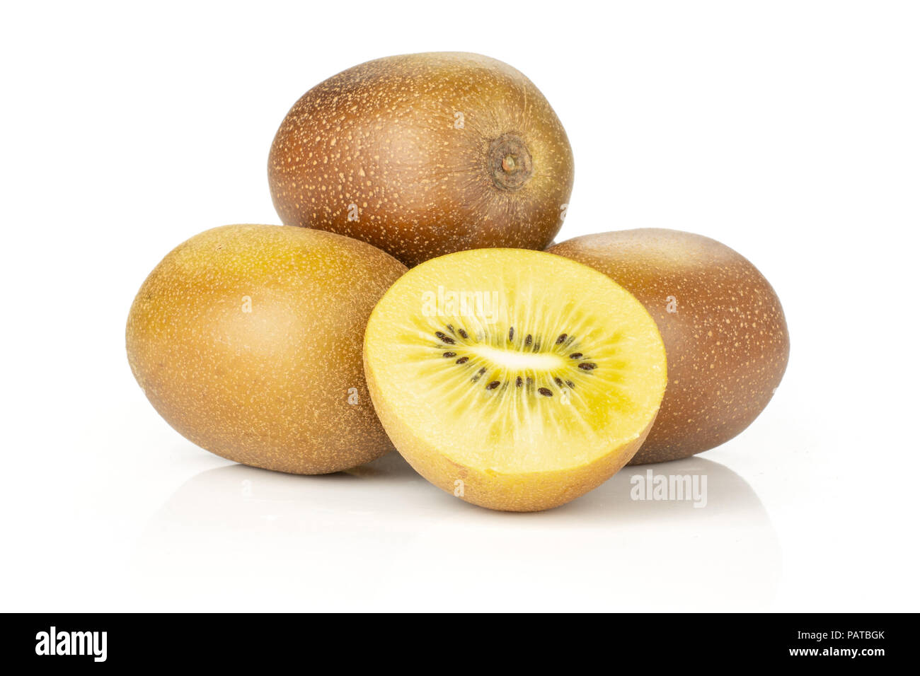 Lot of whole one half of fresh golden brown kiwi fruit sungold variety ...