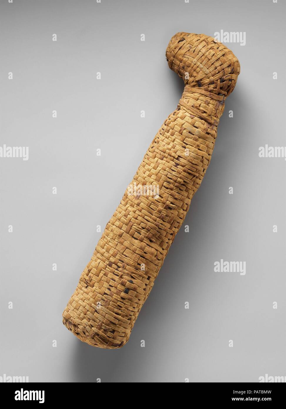 Sacred animal mummy of a cat. Dimensions: H. 34.4 cm (13 9/16 in.); W. 9.5 cm (3 3/4 in.); D. 5.6 cm (2 3/16 in.). Date: ca. 400 B.C.-100 A.D..  Animal cults   The Egyptians considered certain individual animals to be living manifestations of a god, such as, since earliest times, the Apis bull . Those individuals were duly mummifed when they died and buried for eternal life, then replaced by another single living manifestation. During the first millennium BC, many multiples of animals associated with certain gods were specially raised in temple precincts as simultaneous avatars of that god and Stock Photo