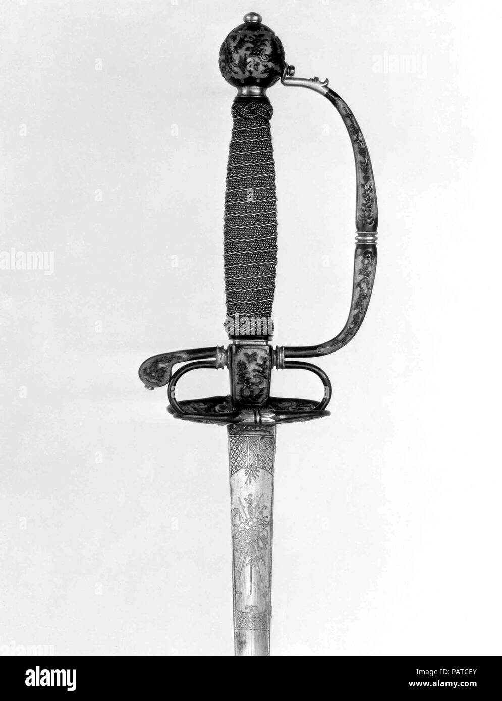 Smallsword Hilt and Blade. Culture: hilt, Japanese, possibly Dejima; blade, European. Dimensions: Hilt (a); L. approx. 7 in. (17.8 cm); W. approx. 4 in. (10.2 cm); Wt. 5.3 oz. (150.3 g); blade (b); L. 40 1/8 in. (101.9 cm); Wt. 5.5 oz. (155.9 g). Date: ca. 1730.  Sword hilts of European fashion made of shakudo, an alloy of copper and gold patinated to the blue-black color that was used in Japan for small decorative objects such as sword mountings, were probably fabricated for the Dutch East India Company at their trading post on the Japanese island of Deshima. Hilt elements like these were the Stock Photo
