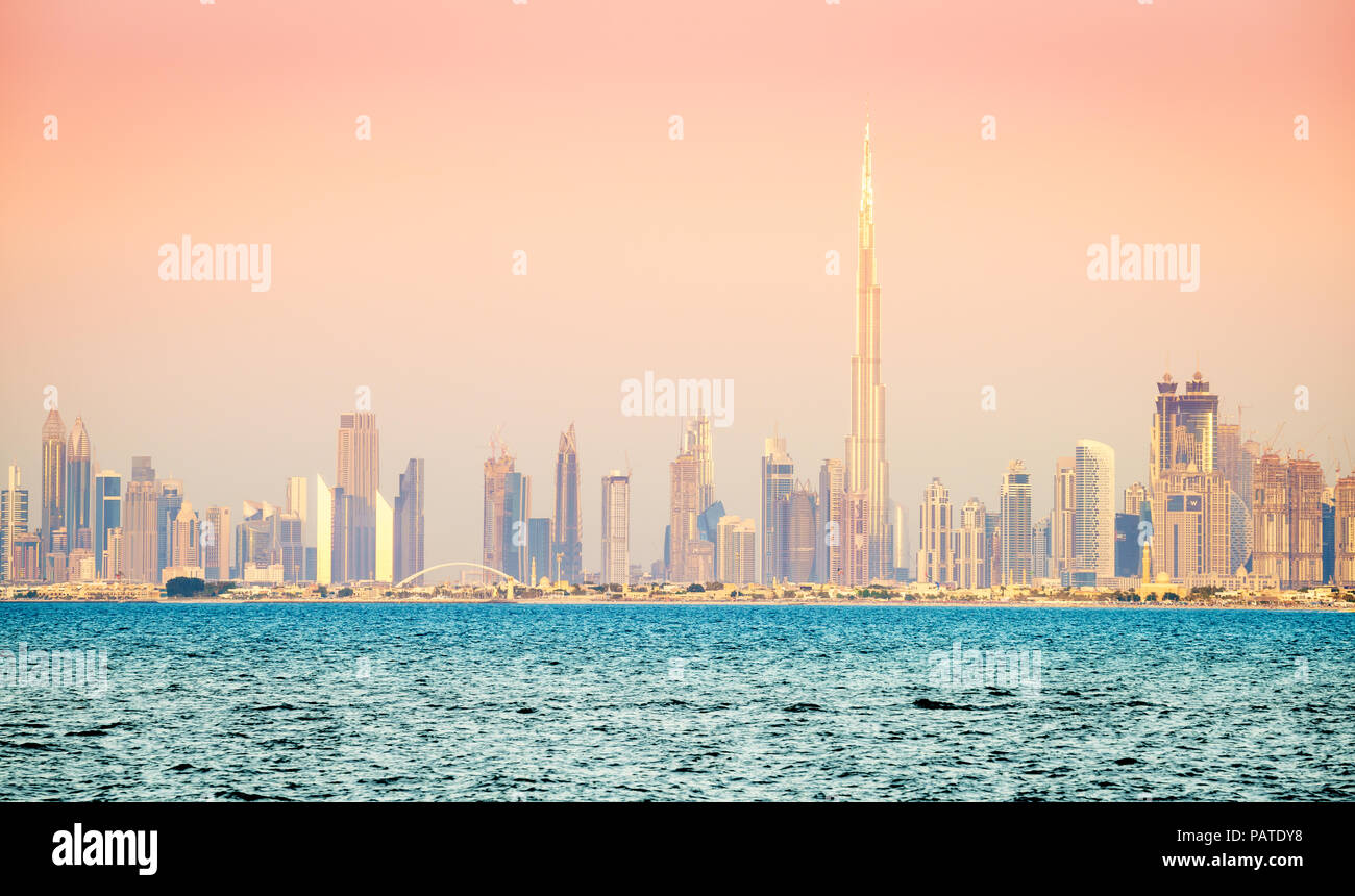 Seaside view of skyline of Dubai's downtown at sunset Stock Photo