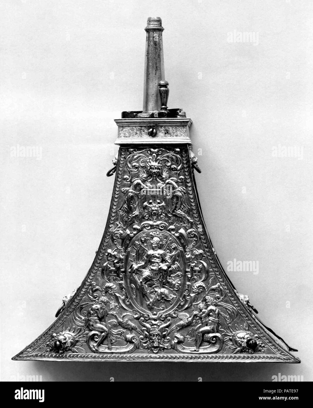 Powder Flask. Culture: French or Flemish. Dimensions: H. 11 1/8 in. (28.4 cm); W. 8 1/2 in. (21.6 cm). Date: ca. 1560-80.  The decoration of the front panel combines motifs from French and Flemish ornament prints. The figure in the central oval represents Mars or another personification of war. Museum: Metropolitan Museum of Art, New York, USA. Stock Photo