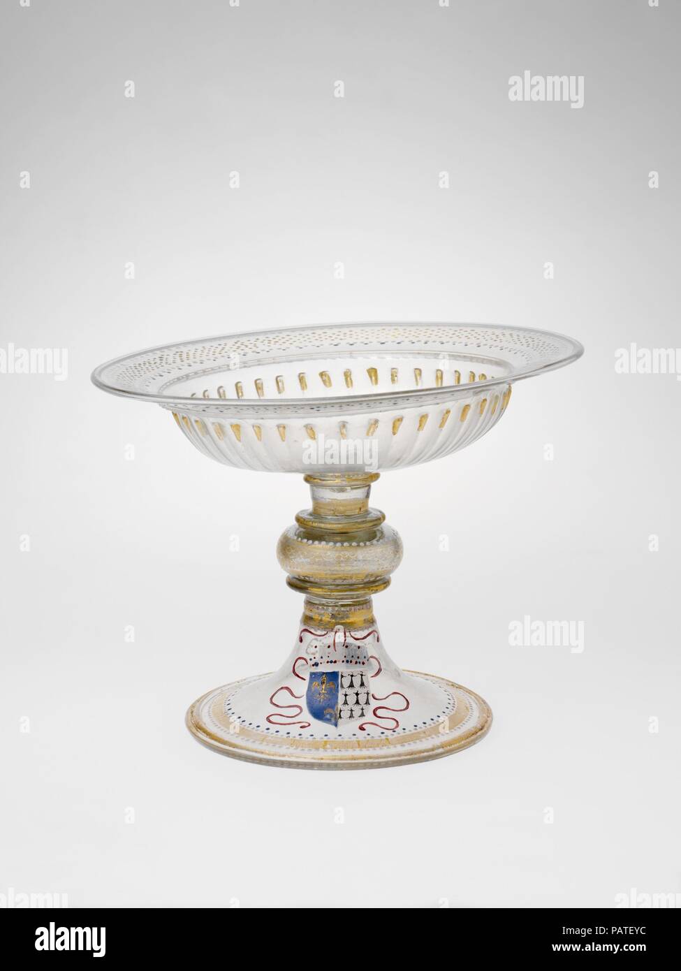 Armorial tazza. Artist: Italian (Venice) or façon de Venise (Venetian-style); Possibly French. Culture: Venetian or façon de Venise, or French. Dimensions: 8 11/16 in.  (22.1 cm); diam. of rim 10 7/8 in. (27.6 cm). Date: 1499-1514.  This tazza bears the coats of arms of Louis XII of France (1462-1515; r. 1498-1515) and Anne, duchess of Brittany (1477-1514). It is believed to have been part of a service made to celebrate their marriage, which took place in 1499. Three other pieces from this presumed service are known. French glassmakers were able to emulate Venetian examples of the period; thou Stock Photo