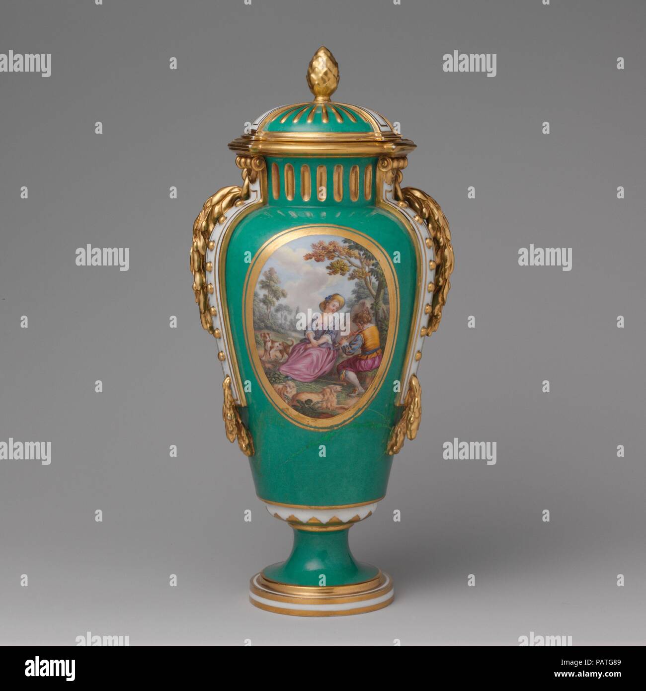 Vase with cover (vase à bandes) (one of a pair). Artist: After engravings by Louis Crépy (French); Based on a composition by Antoine Watteau (French, Valenciennes 1684-1721 Nogent-sur-Marne). Culture: French, Sèvres. Decorator: Gilded by Henry-Martin Prévost (French, active 1757-97); Figures by Charles Nicolas Dodin (French, Versailles 1734-1803 Sèvres). Dimensions: H. 12 15/16 in. (32.9 cm.). Factory: Sèvres Manufactory (French, 1740-present). Date: ca. 1770-75.  The bucolic scenes on the front of these vases (see also 58.75.68a, b) are after compositions by the French painter Jean-Antoine Wa Stock Photo