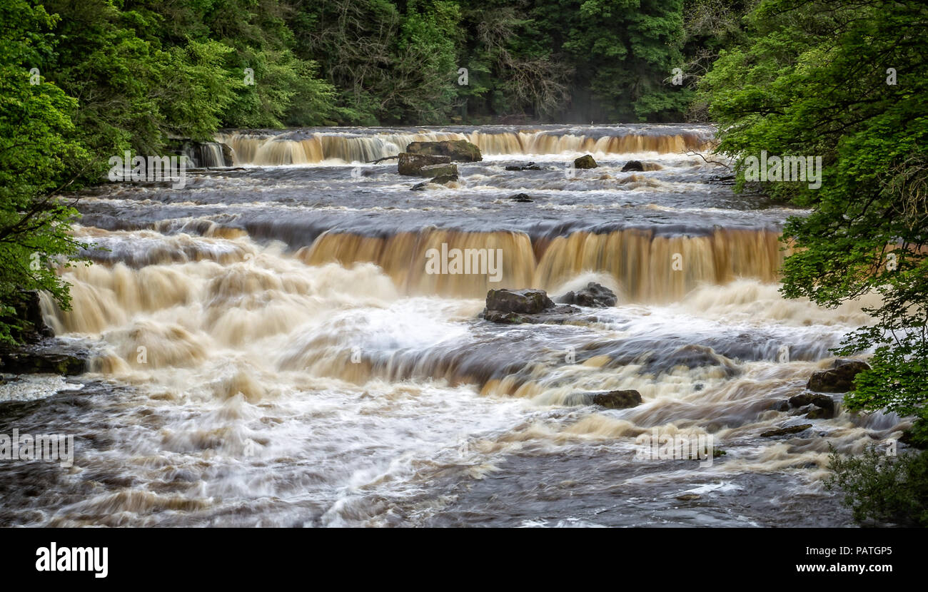 Dramatic shot of raging water cascading down river Stock Photo