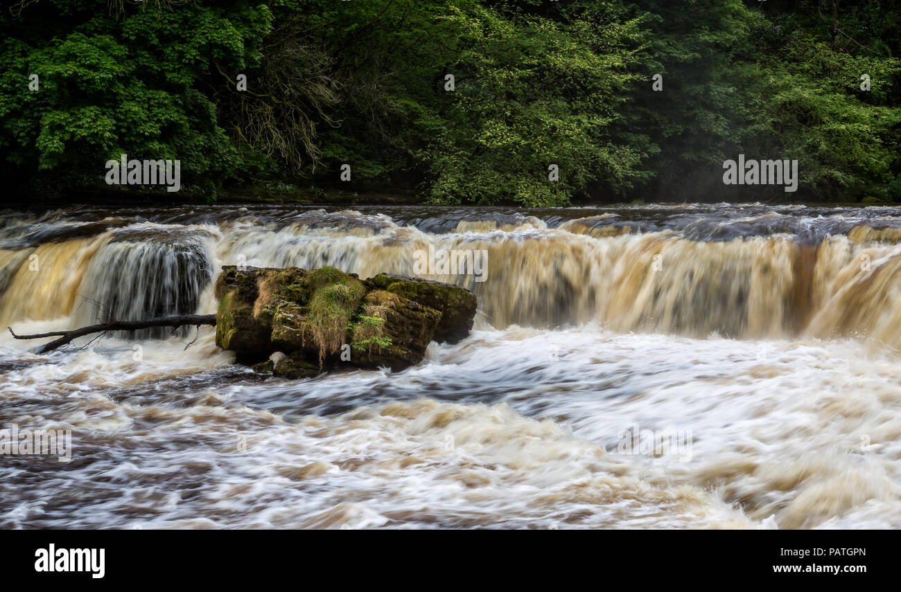 Dramatic shot of raging water cascading down river Stock Photo