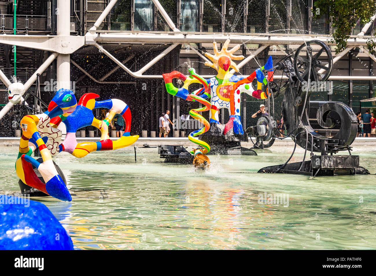 A dog plays in the Stravinsky Fountain, next to the Centre Pompidou