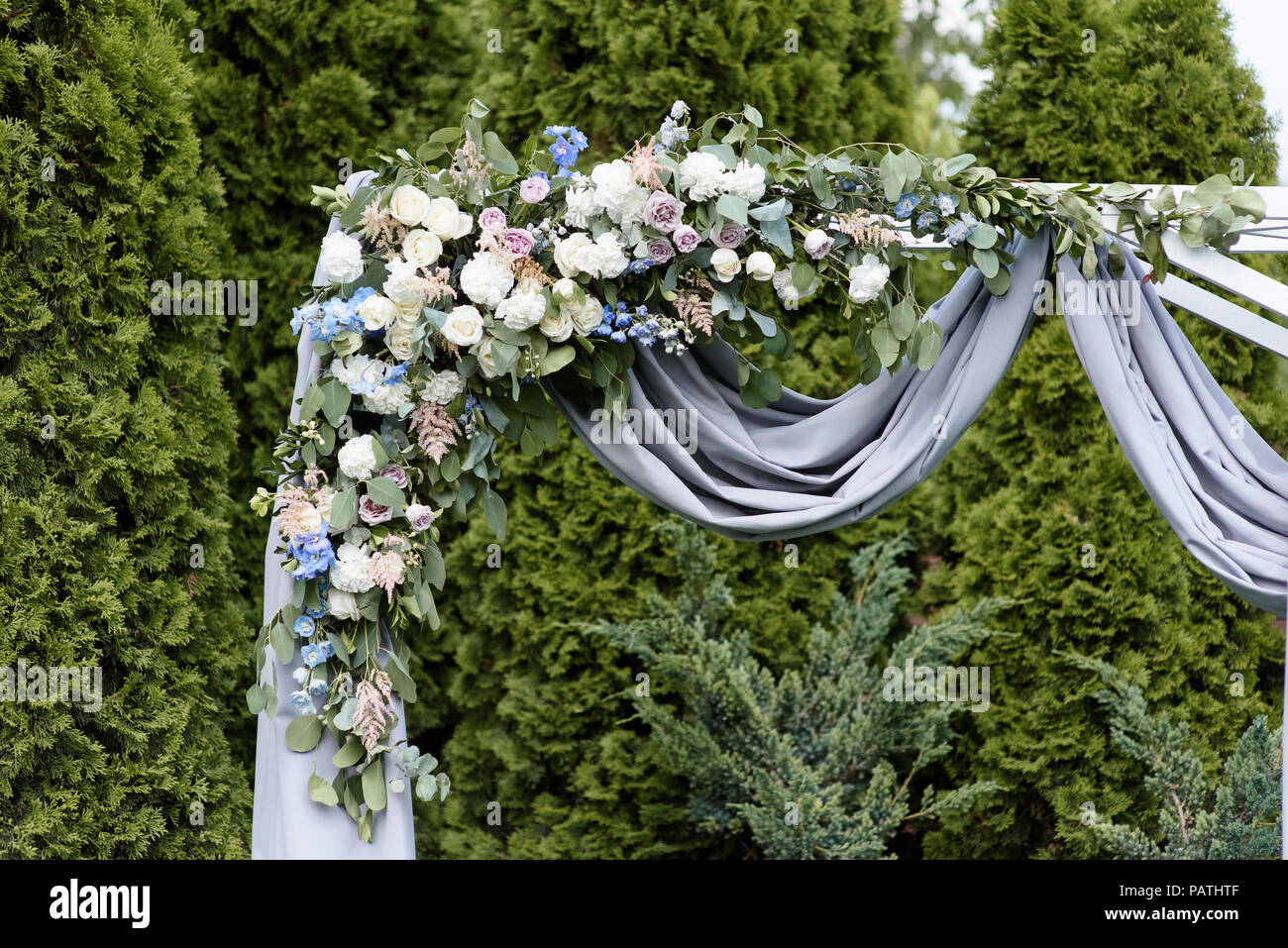 The stylish arch decorated with flowers and fabric Stock Photo Alamy
