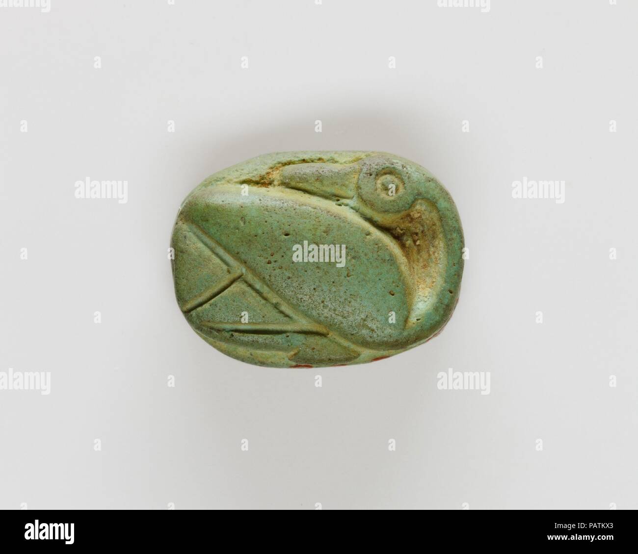 Plaque Decorated with a Duck. Dimensions: L. 1.2 cm (1/2 in.); W. 0.9 cm (3/8 in.); Th. 0.5 cm (3/16 in.). Dynasty: Dynasty 18, early. Reign: reign of Thutmose II-Early Joint reign. Date: ca. 1492-1473 B.C..  This seal-amulet was found with twenty-three scarabs and seal-amulets in the coffin of a young woman who was buried in Hatnefer's tomb (see 36.3.1 and 36.3 26). The back is carved in the shape of a duck carved  and the base is inscribed with a decorative floral pattern. Museum: Metropolitan Museum of Art, New York, USA. Stock Photo