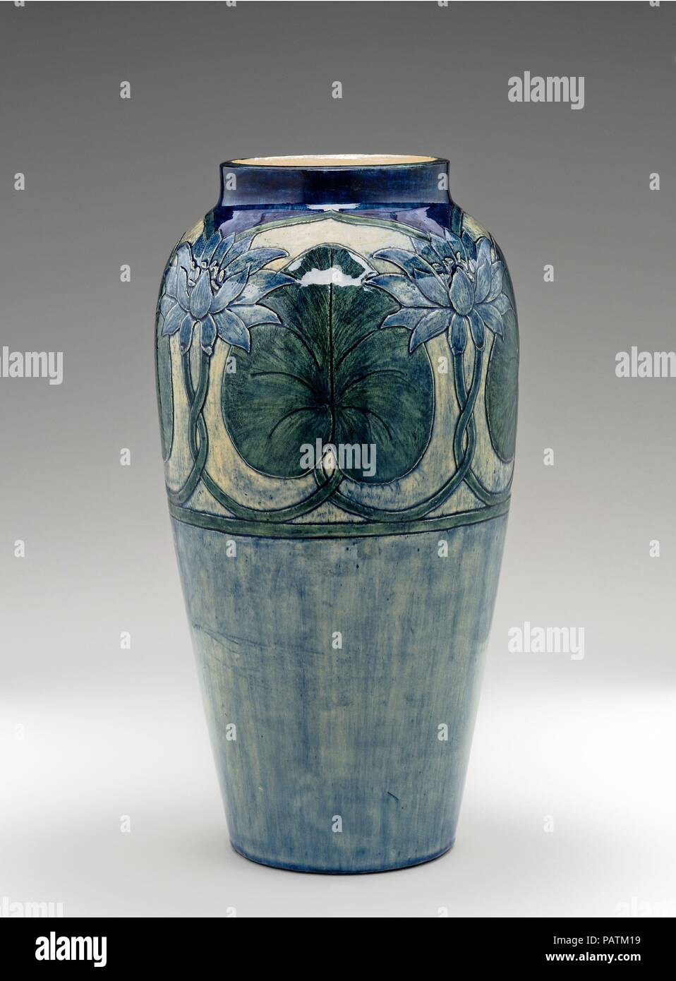 Vase. Culture: American. Dimensions: 16 1/8 x 8 7/16 in. (41 x 21.4 cm). Maker: Possibly decorated by Marie Medora Ross (1844-1920). Manufacturer: Newcomb Pottery (1894-1940). Date: 1902.  Newcomb College of New Orleans is one of the earliest educational institutions to be associated with the Arts and Crafts Movement. It shared many of the movement's concerns, such as creating opportunities for women in the arts. It was the brainchild of Ellsworth Woodworth, who taught drawing and painting at Newcomb, and his brother William Woodward, professor at Tulane University, who was especially interest Stock Photo