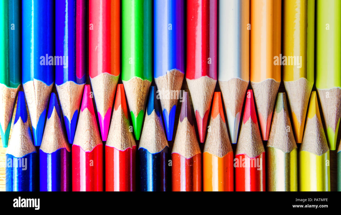multicolored rainbow colors pencils on dirty wooden textured background ...