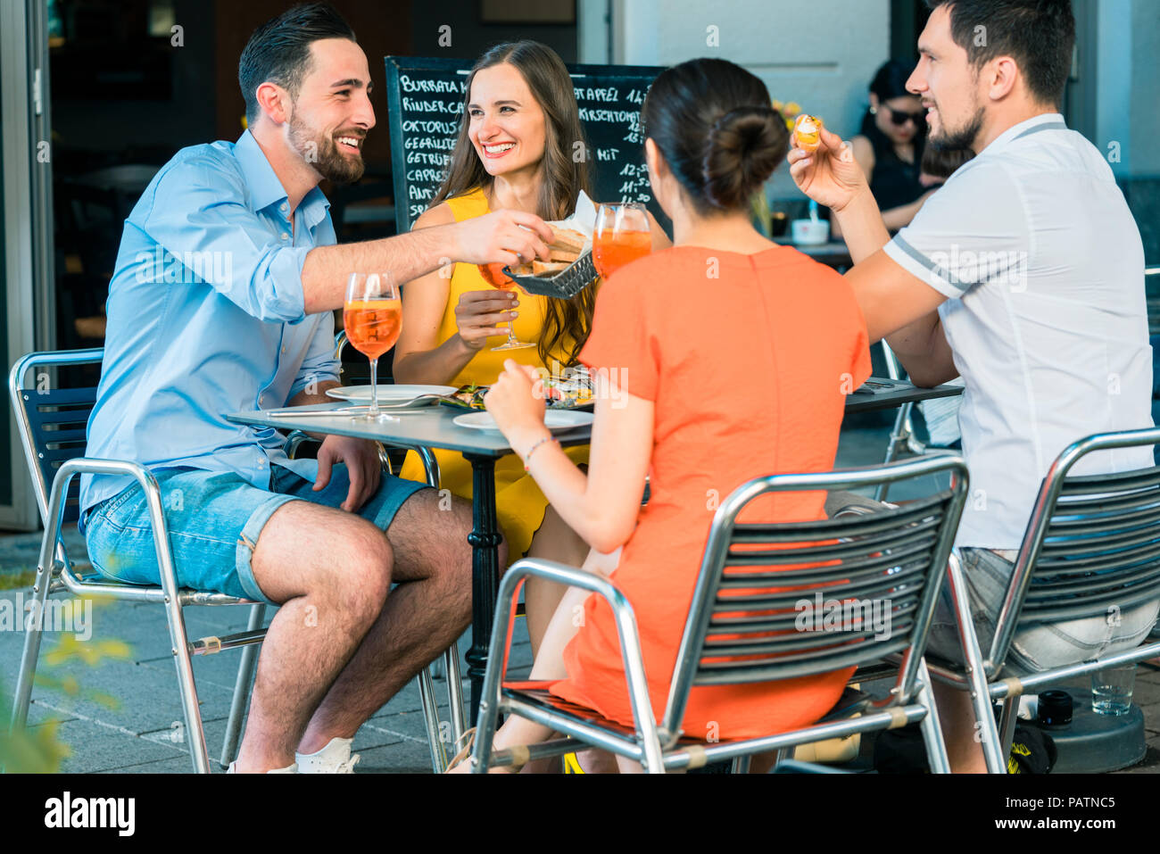 Cheerful friends toasting with a refreshing summer drink Stock Photo