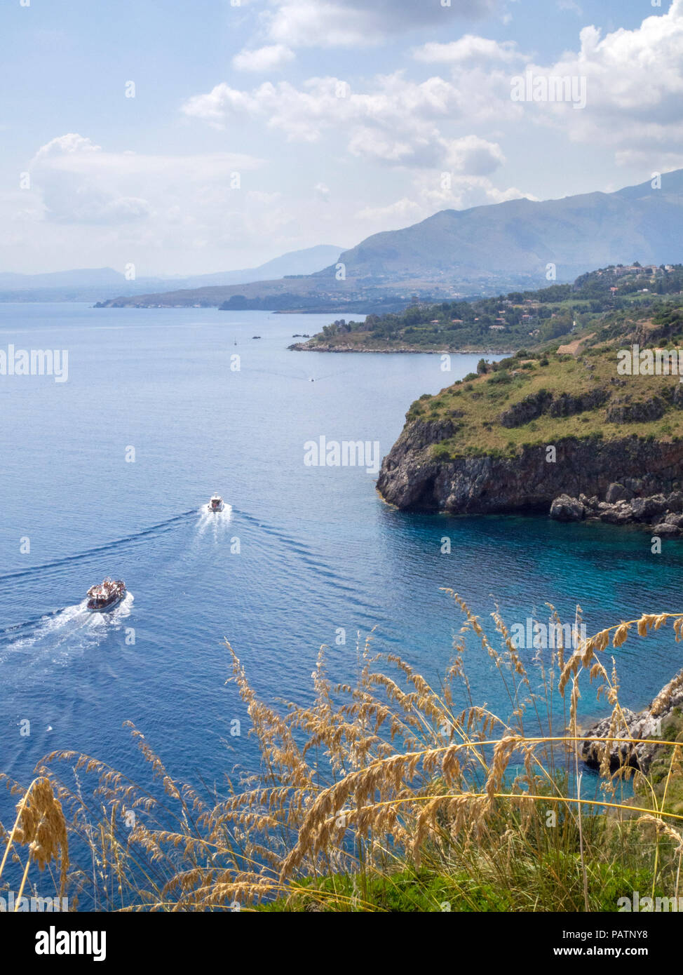 Boats sailing past in Zingaro Nature Reserve, a scenic coastal reserve