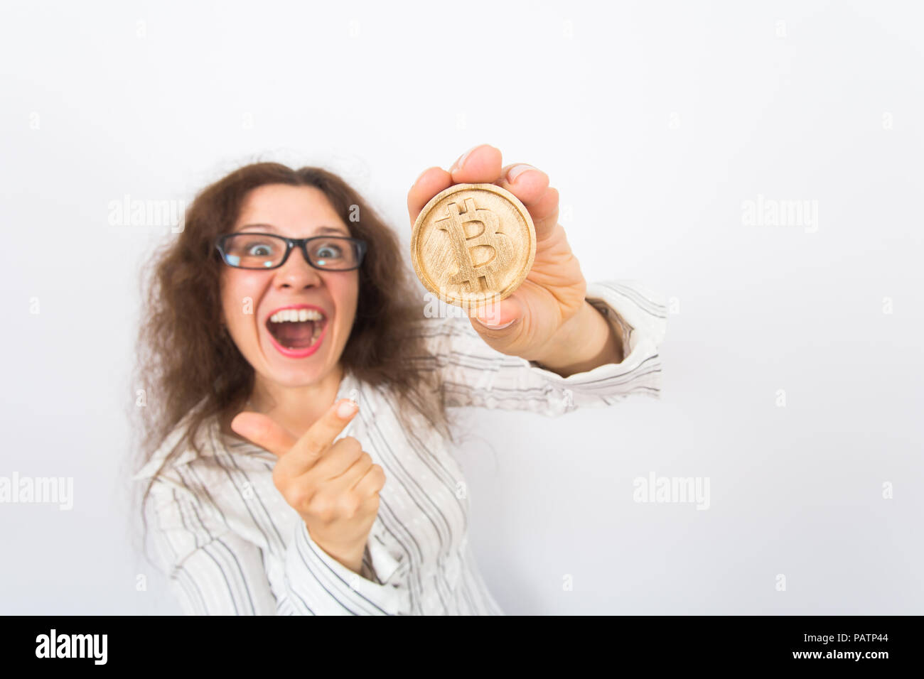 Cryptocurrency, virtual money and future concept - Young funny woman holds  a big gold bitcoin in her hand Stock Photo - Alamy