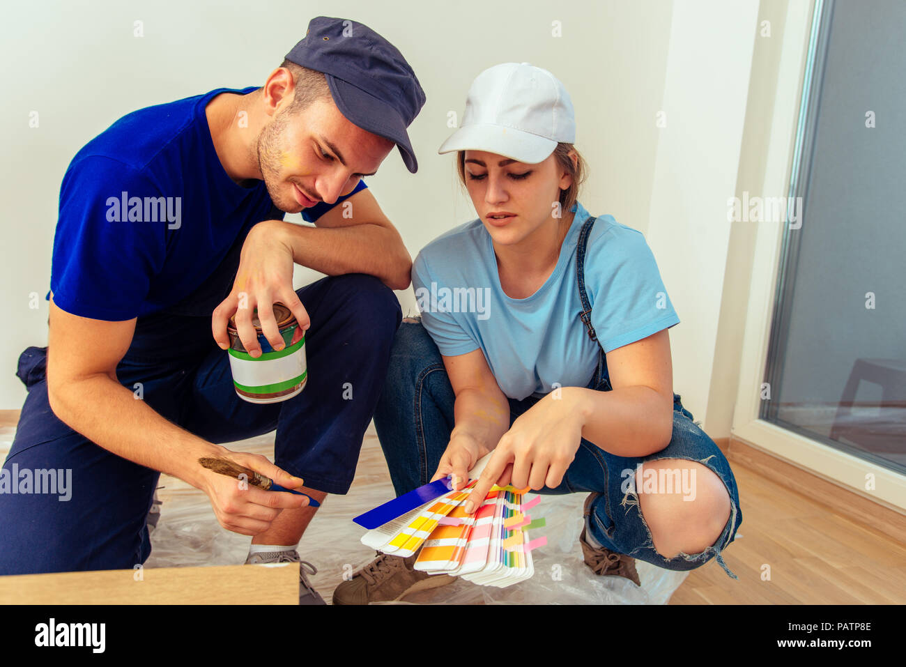 Cute girl holding color guide while choosing true color with her ...