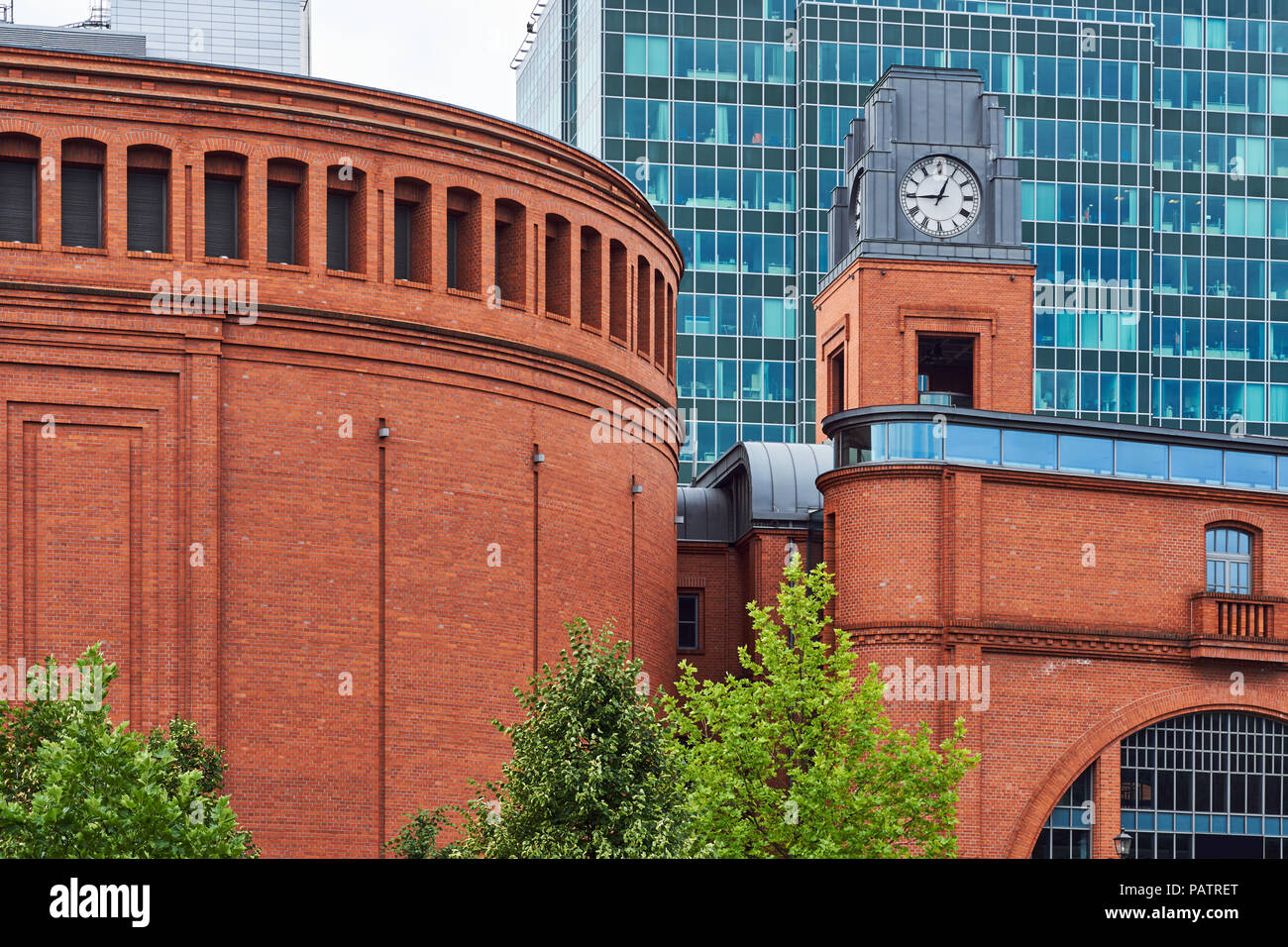 Buildings of Stary Browar with a clock tower and facade of a modern office building  in Poznan Stock Photo