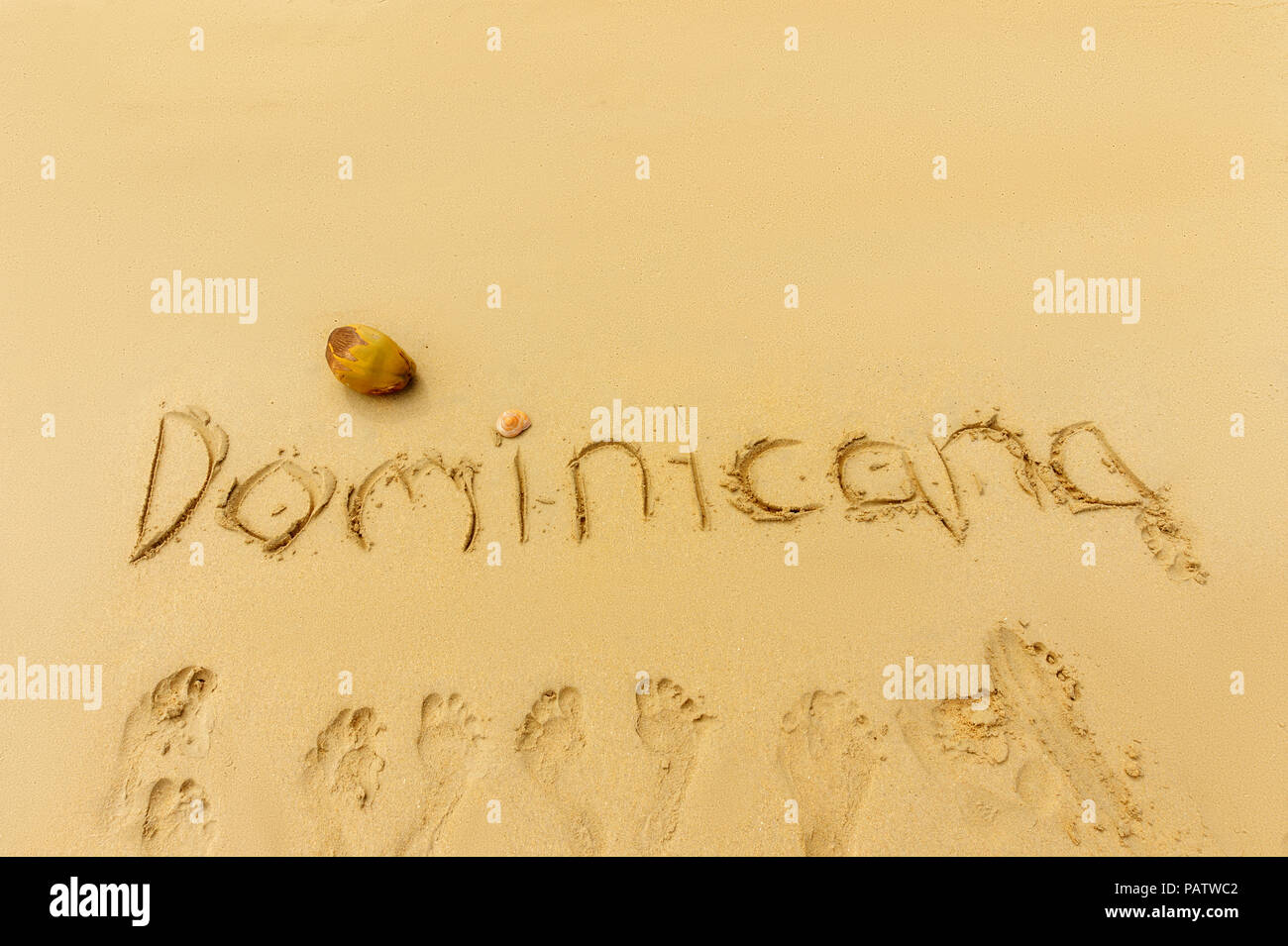 exotic vacation concept. Dominican republic written on the sand and footprints on the sand Stock Photo