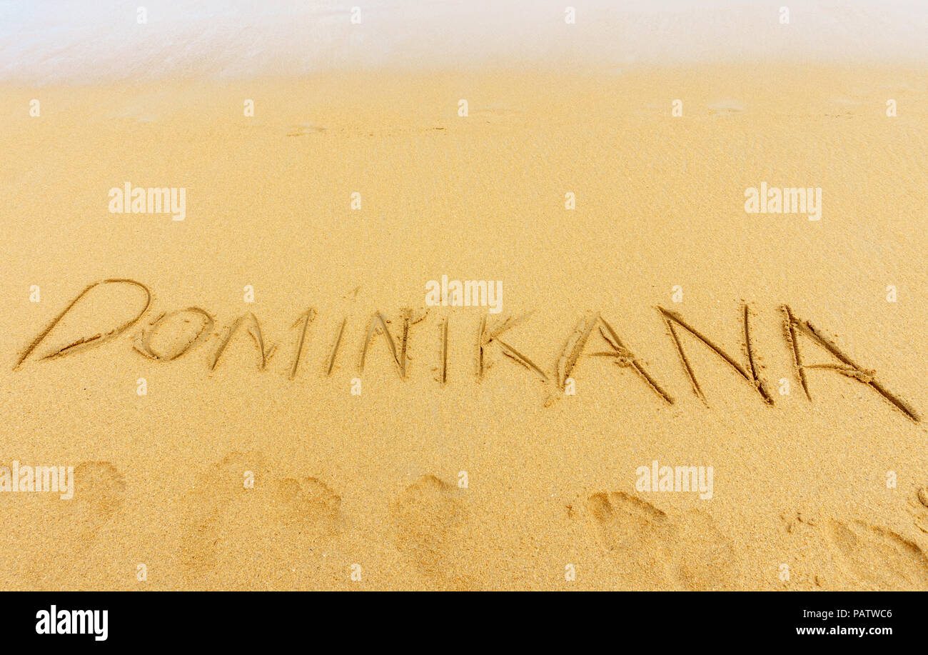 exotic vacation concept. Dominican republic written on the sand and footprints on the sand Stock Photo