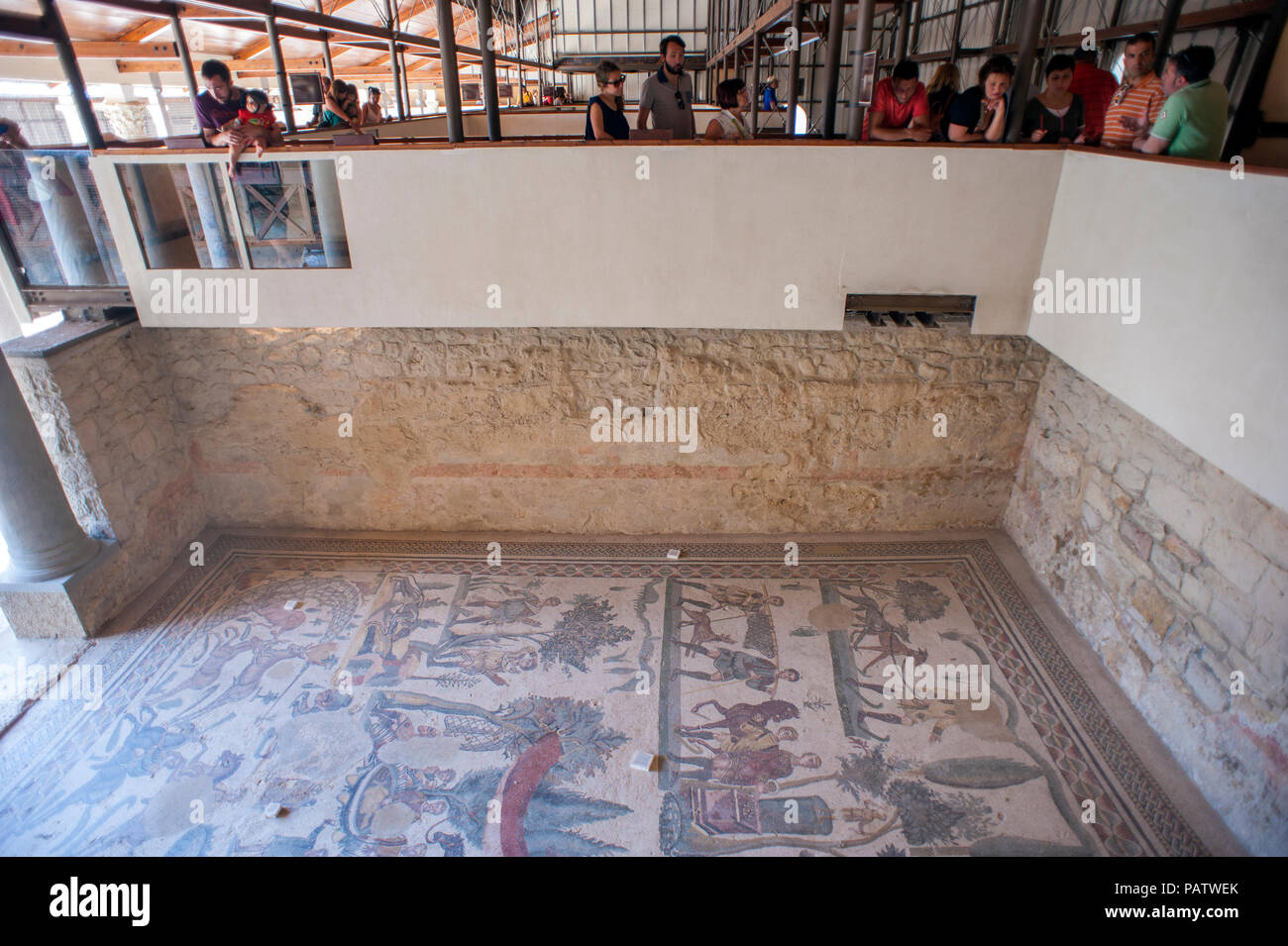 Tourists looking at the 4th century tile mosaics at Villa Romana del Casale, an ancient Roman villa located outside of Piazza Armerina in central Sici Stock Photo
