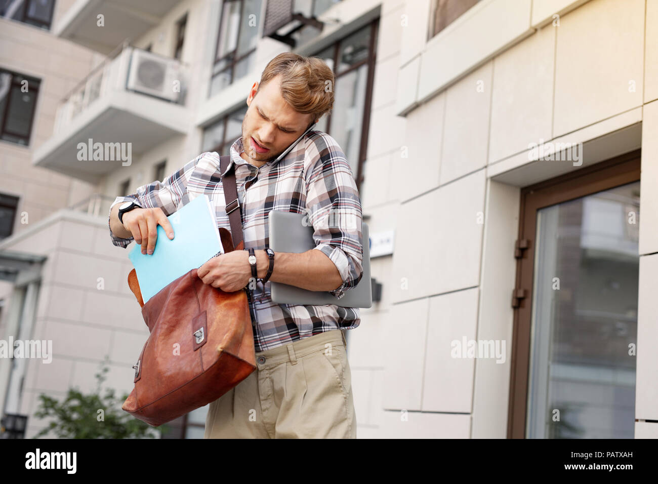 Serious nice man holding his notebook Stock Photo
