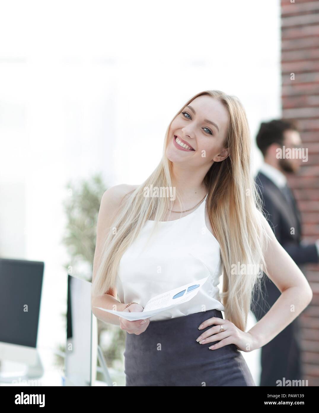 portrait of an elegant young business woman on the office background ...