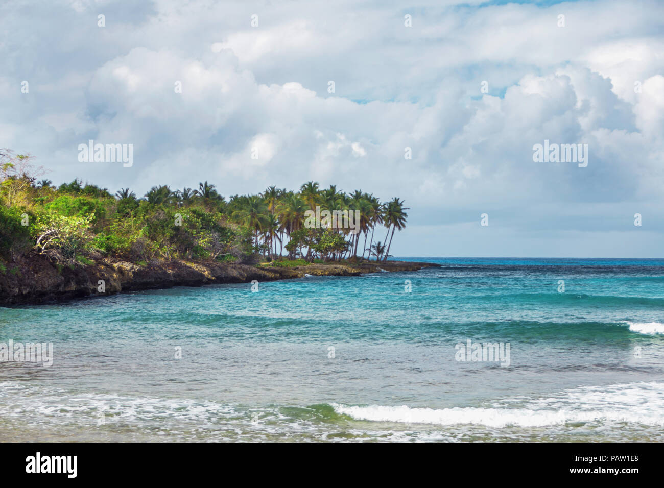 vacation paradise in Samana, Dominican Republic. Sea, shore with palm trees and sky with storm clouds Stock Photo