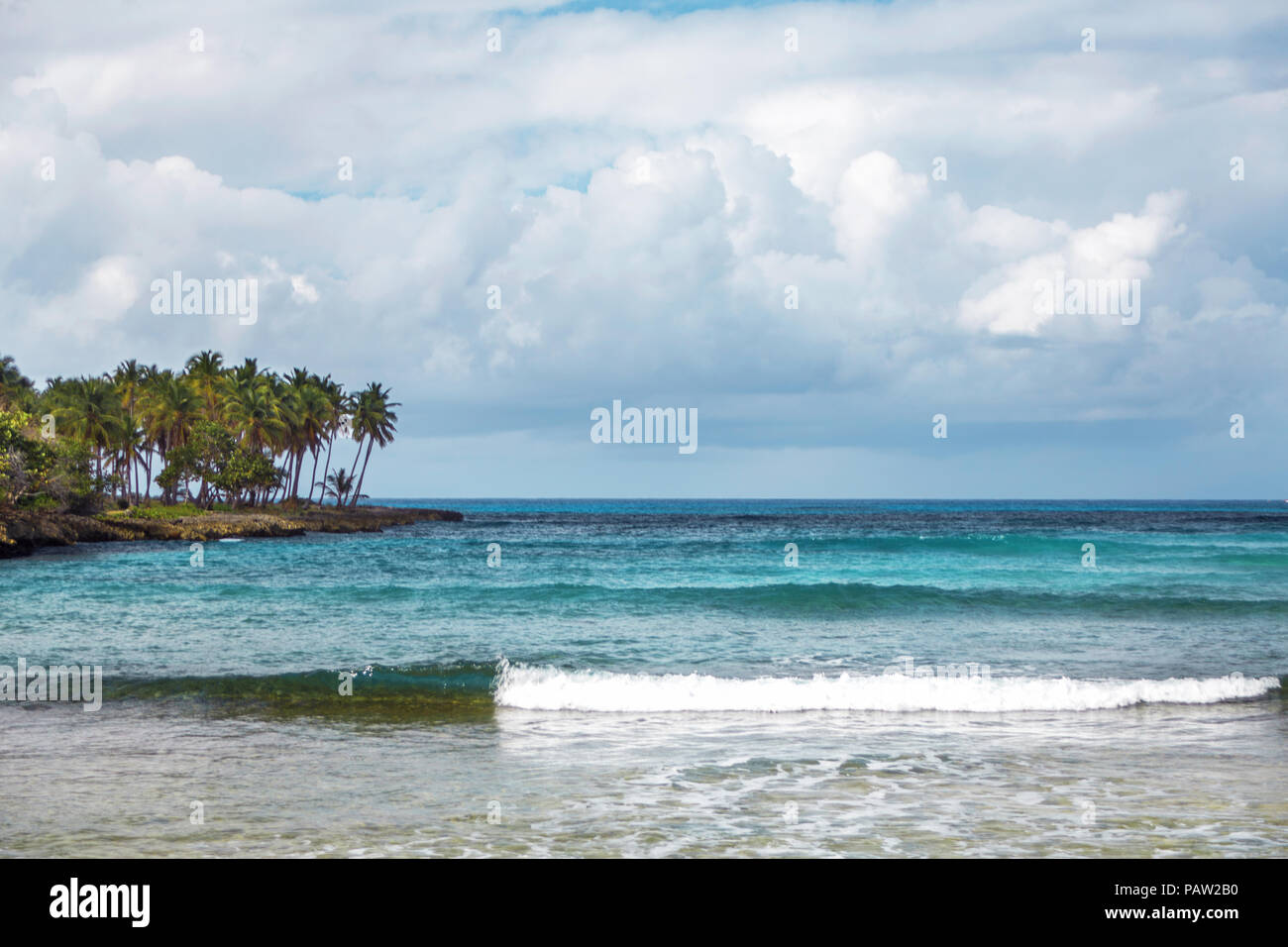 seascape in Samana, Dominican Republic. Sea, shore with palm trees and sky with storm clouds Stock Photo
